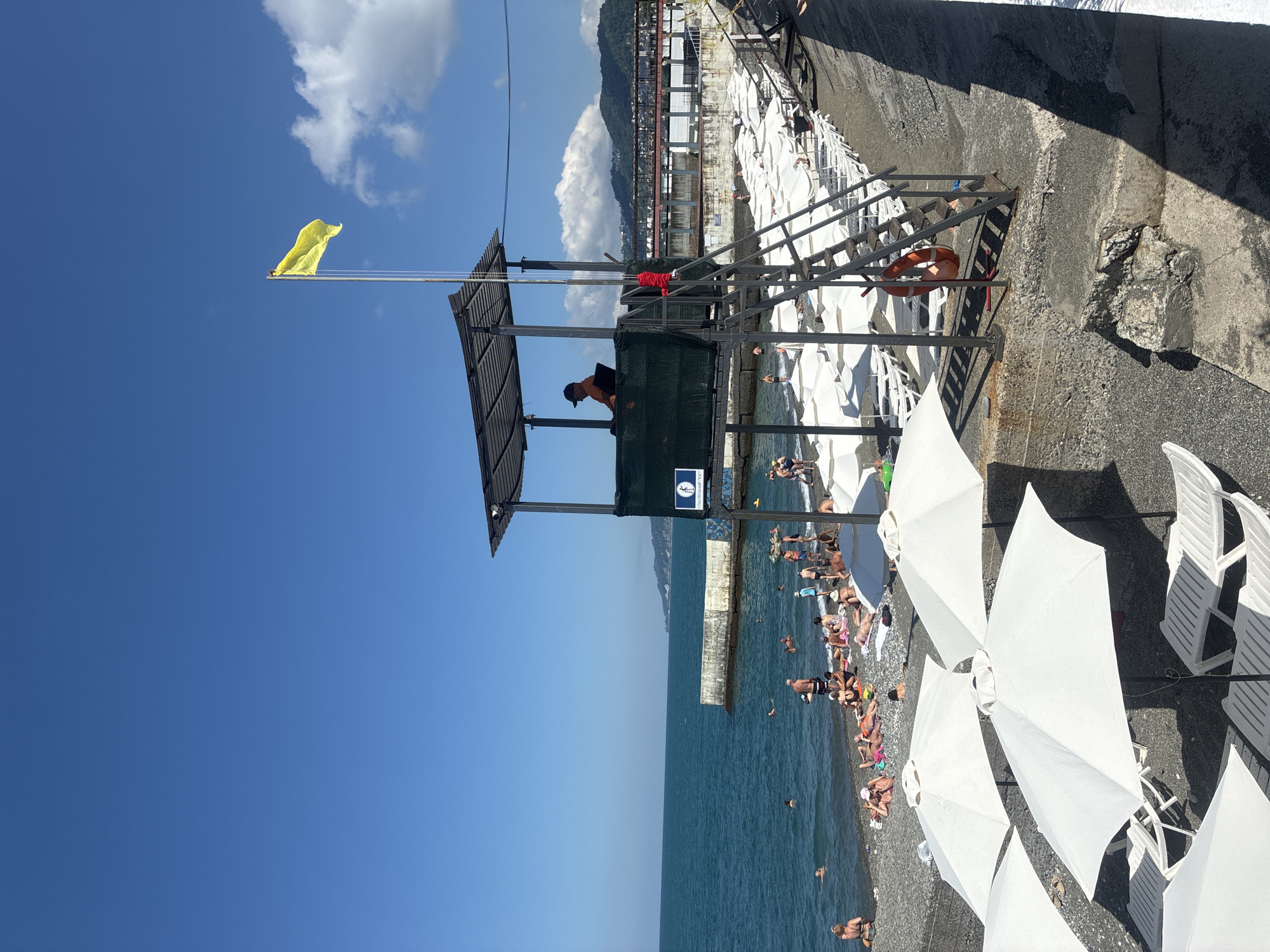 Crowded summer beach day on Sochi's pebble shore