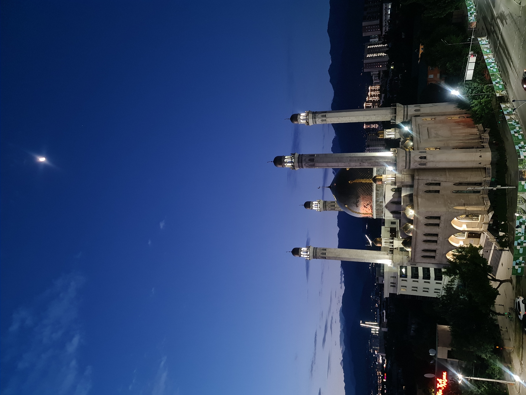 Almaty's Central Mosque and skyline at dusk