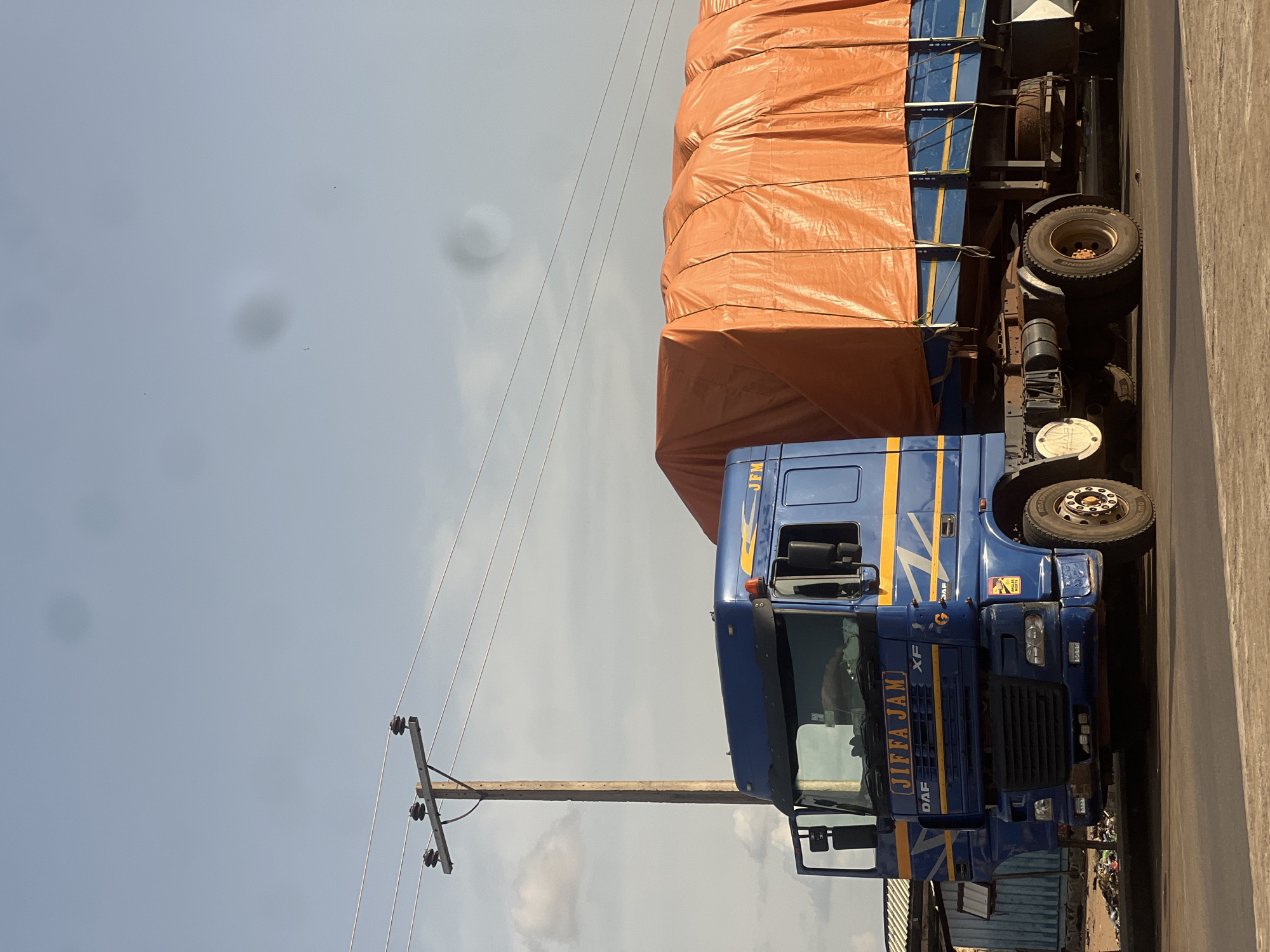 Commercial roadside strip in Jalingo, Nigeria, mid-afternoon