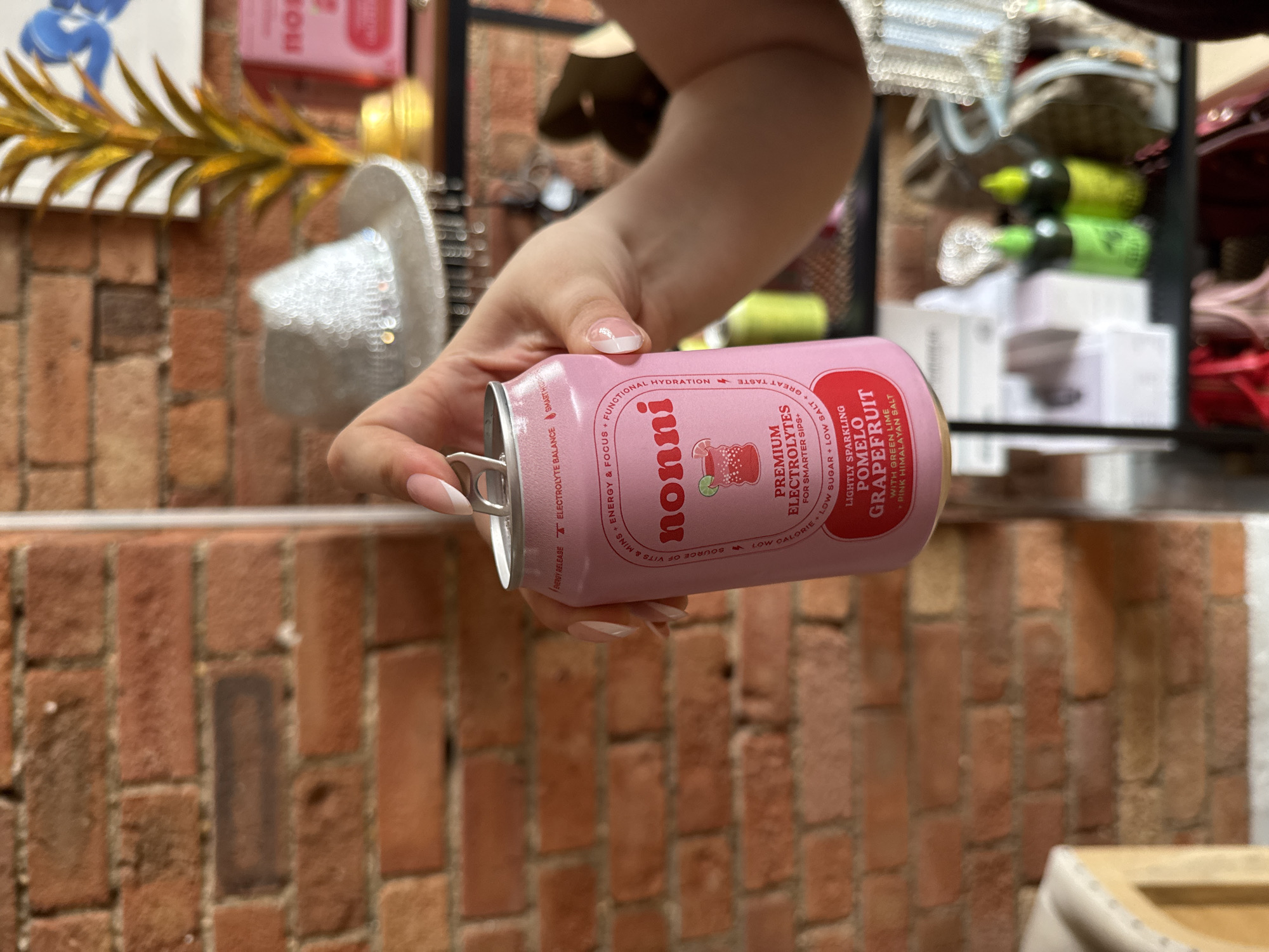 Nonni electrolyte drink spotted open near a London brick wall