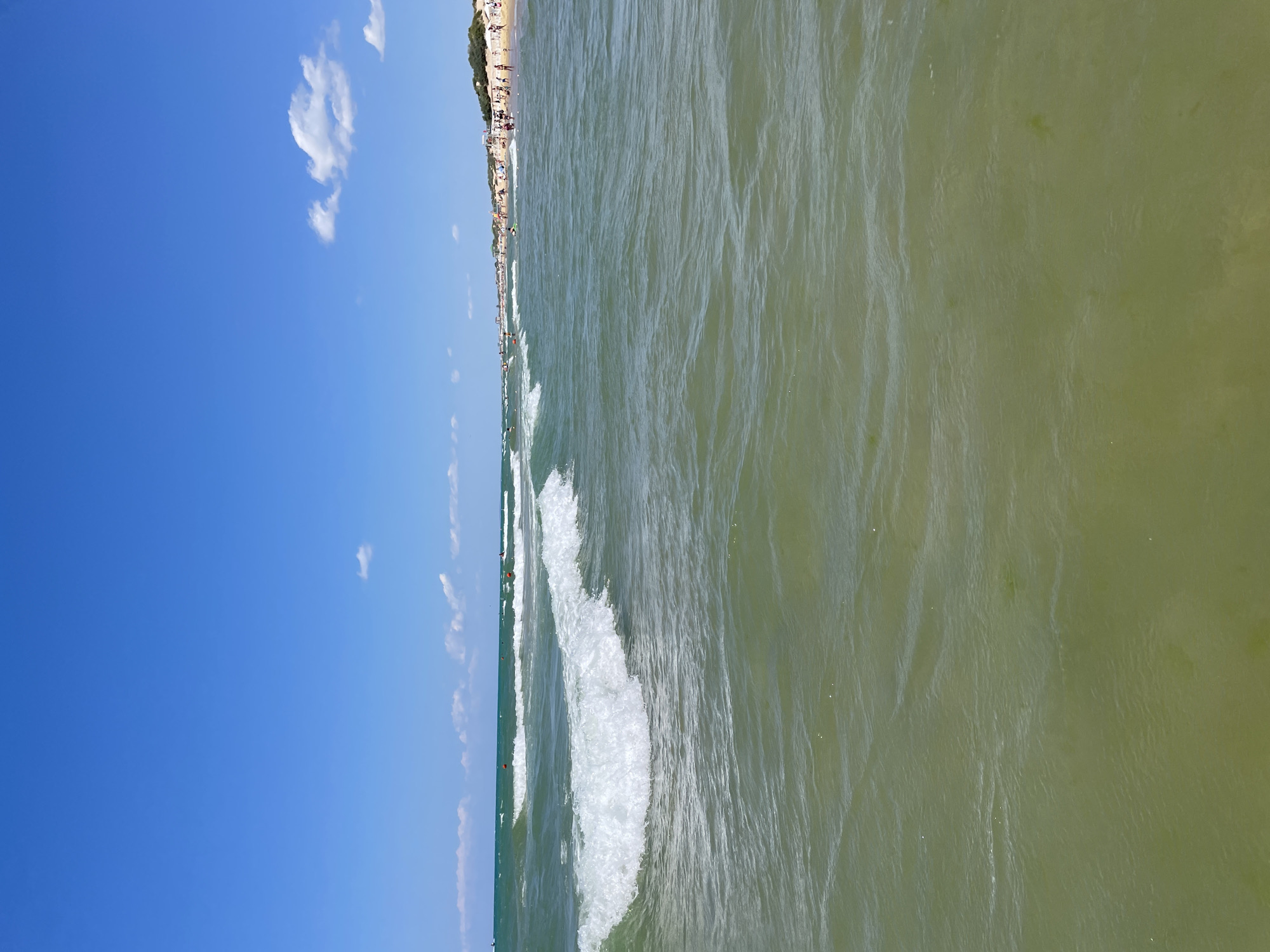 Sunny day at Anapa beach, calm green water and gentle waves
