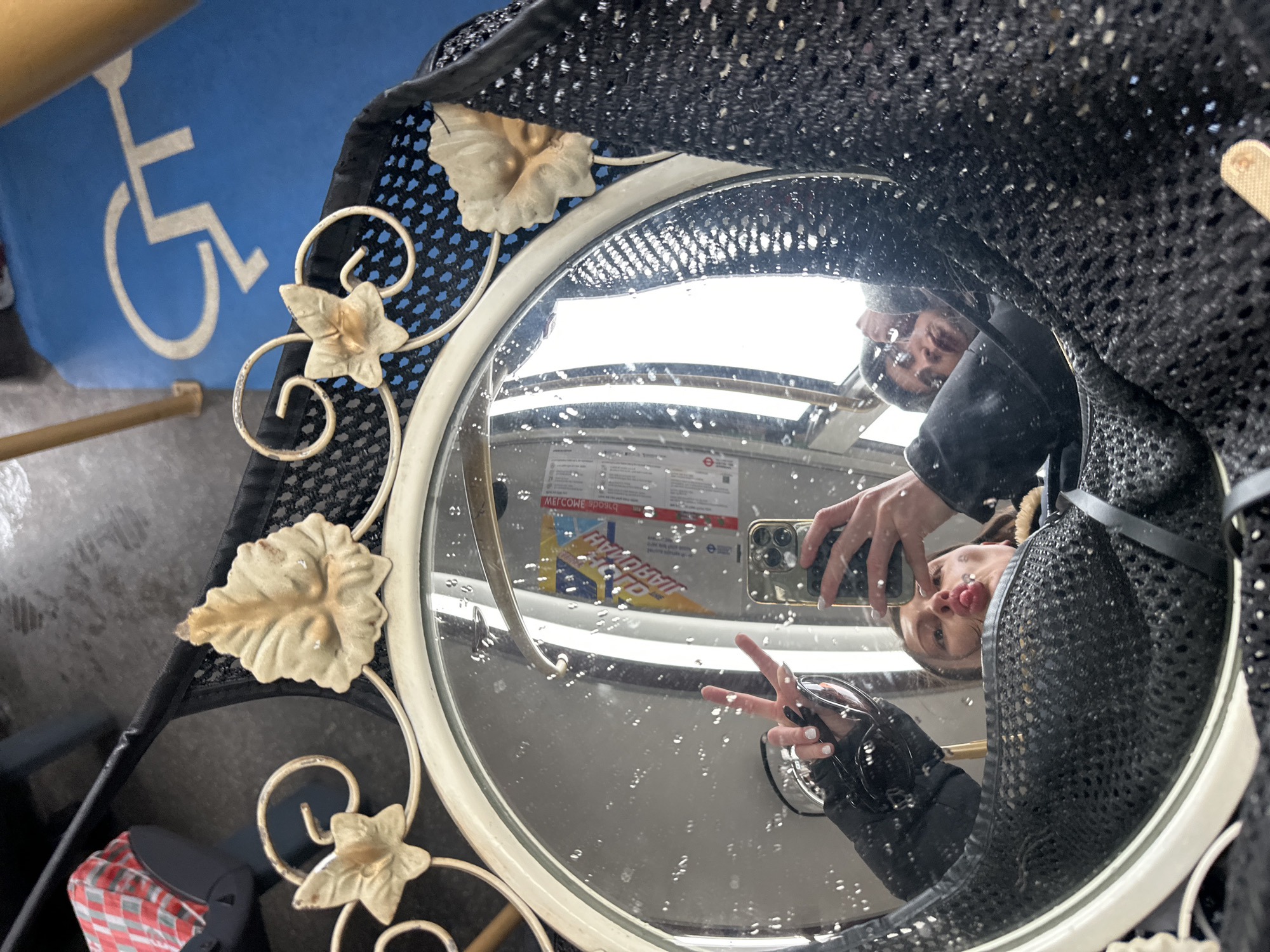 Person takes mirror selfie with peace sign in London