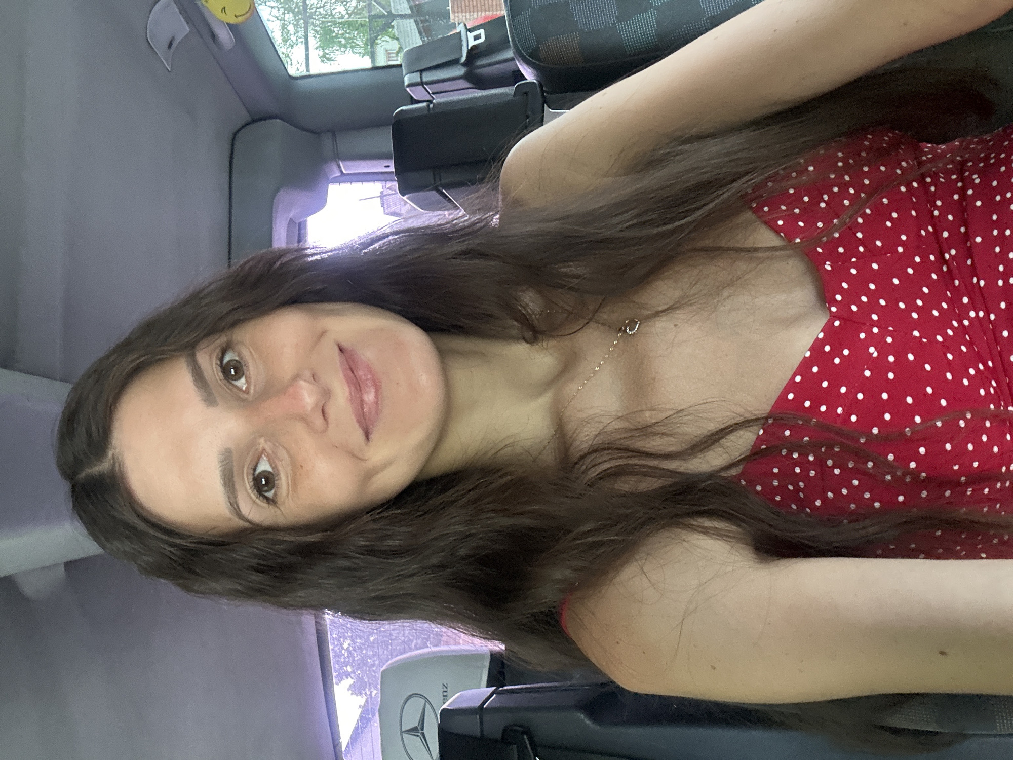 Woman in polka-dot dress photographed in vehicle, Wisła