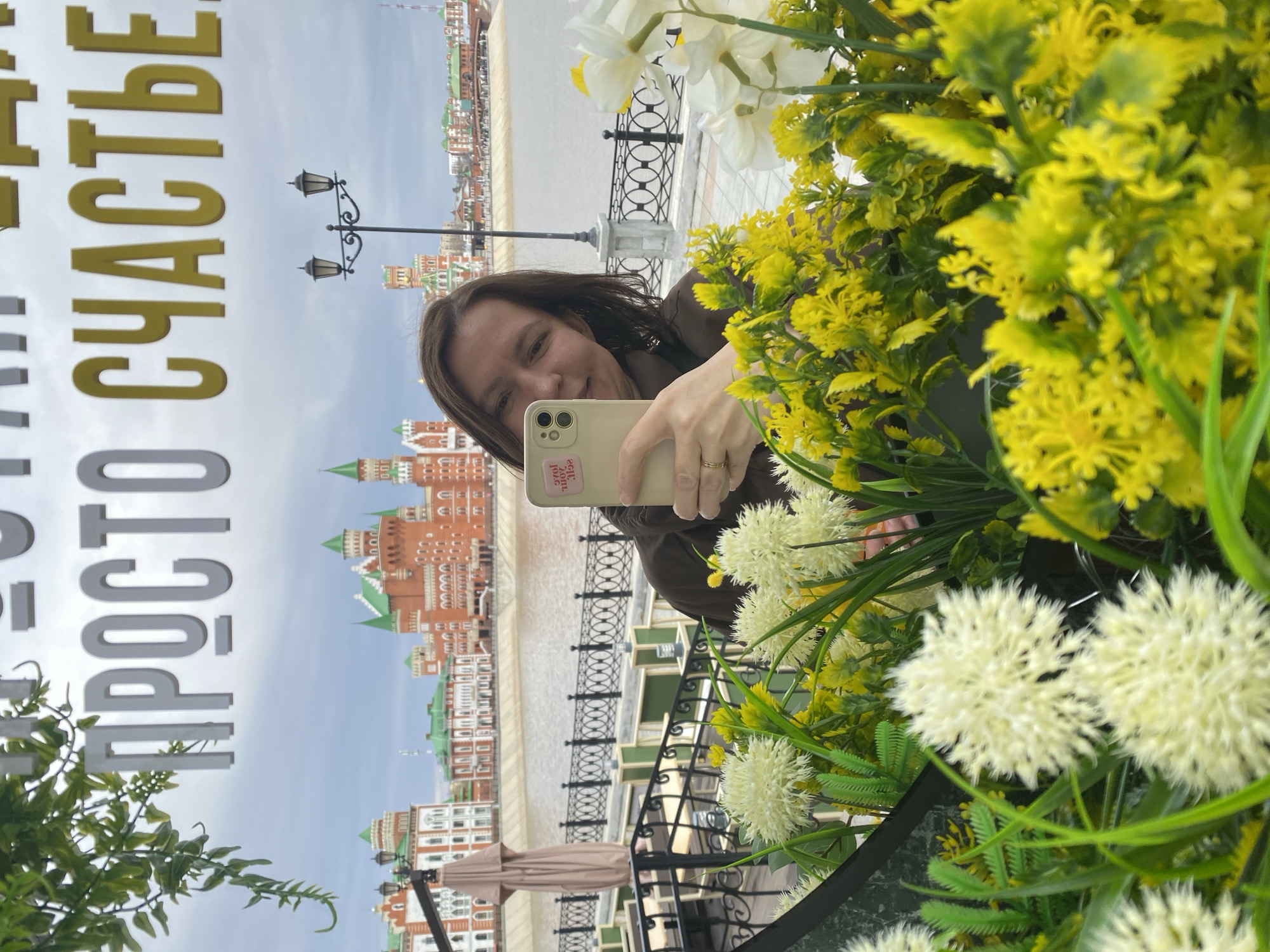 Woman takes mirror selfies in decorated Yoshkar-Ola cityscape