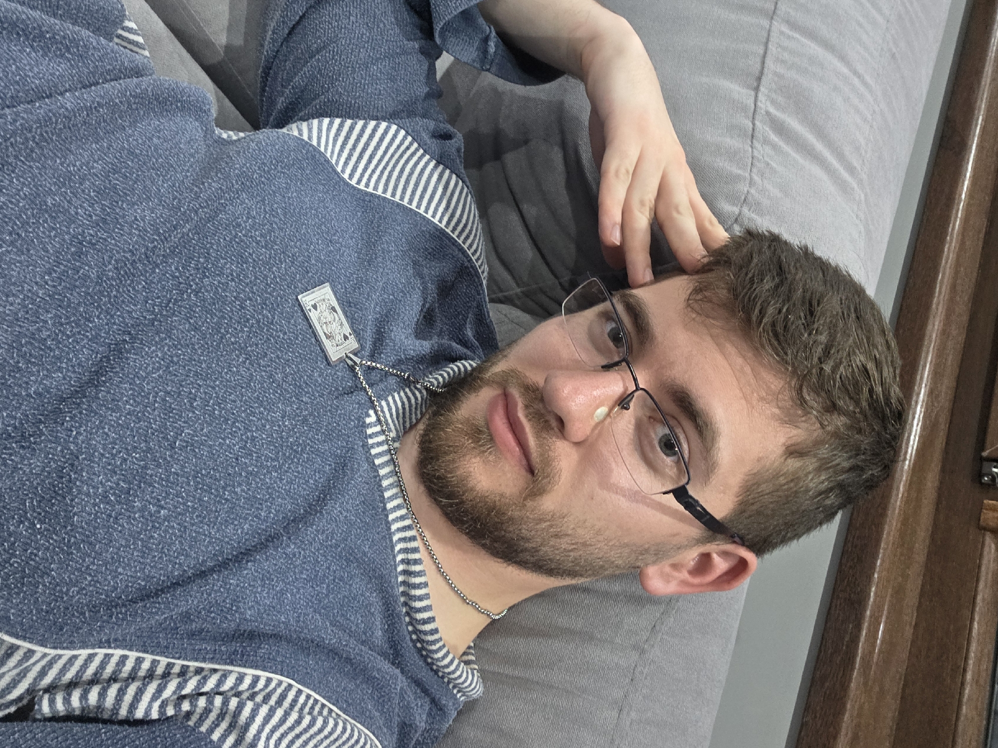 Man relaxes on couch with book in Bulgarian home