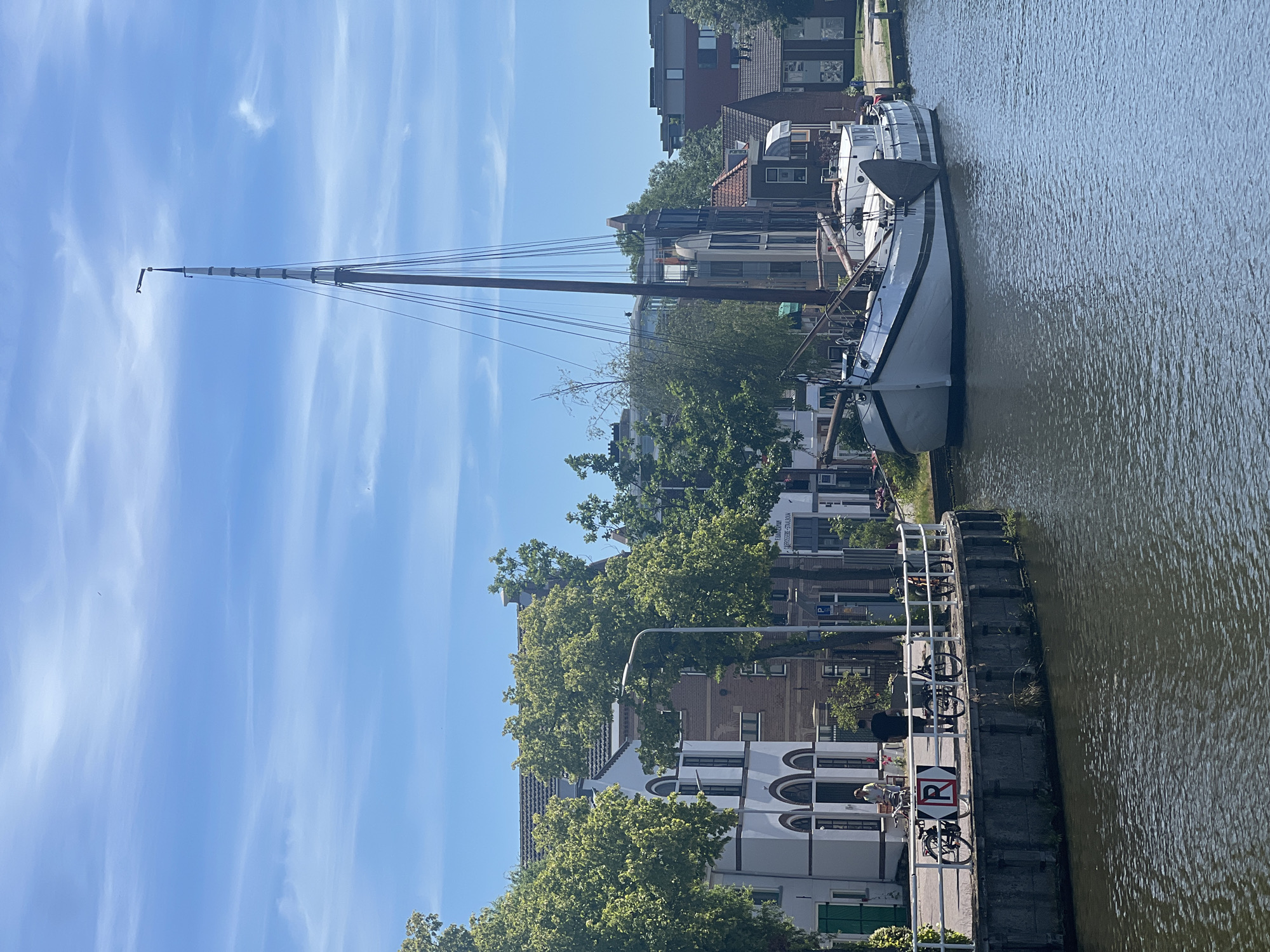 White sailboat moored on a quiet Delft canal