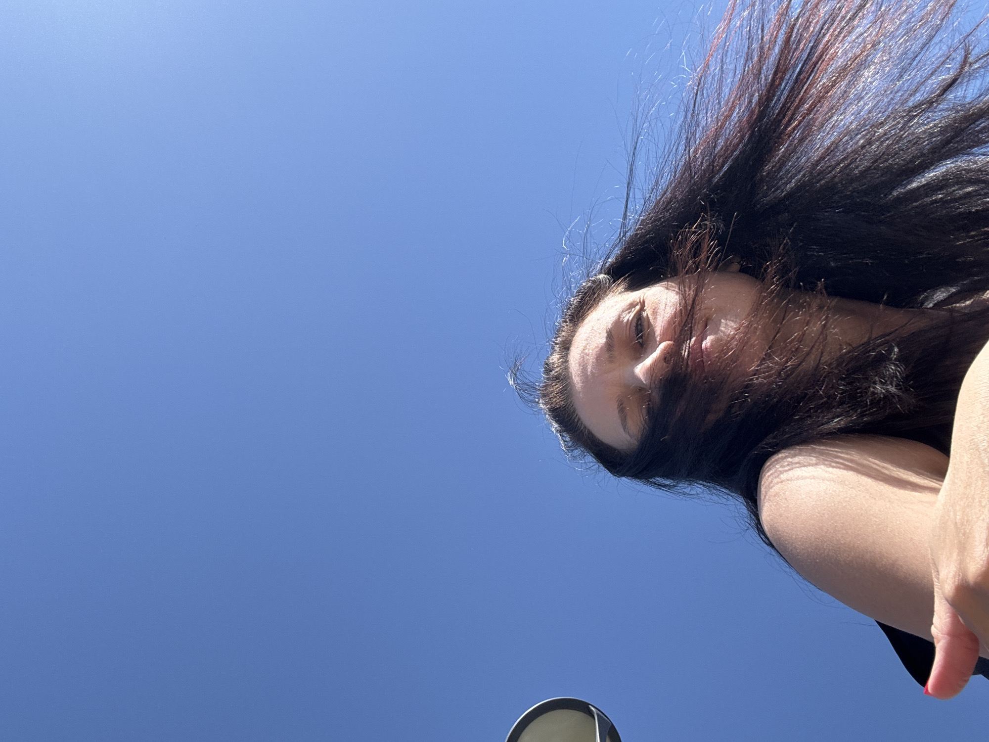 Windblown portrait captured against blue sky in Chaikovsky