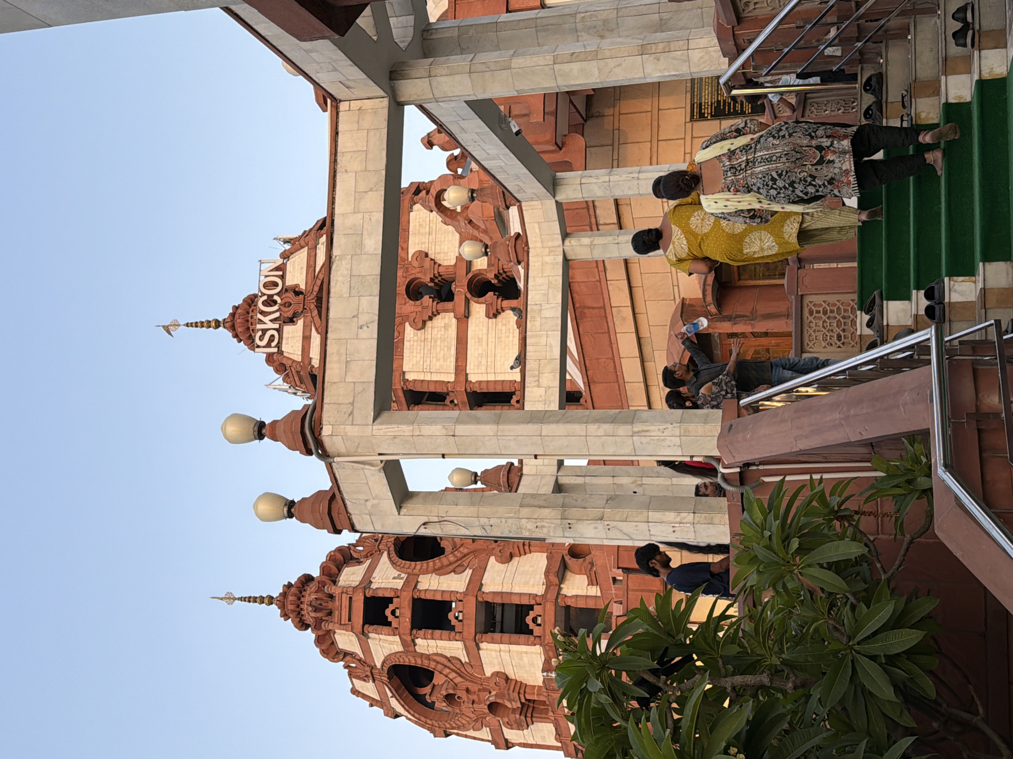 Inside and outside Delhi's ISKCON Temple on a busy afternoon