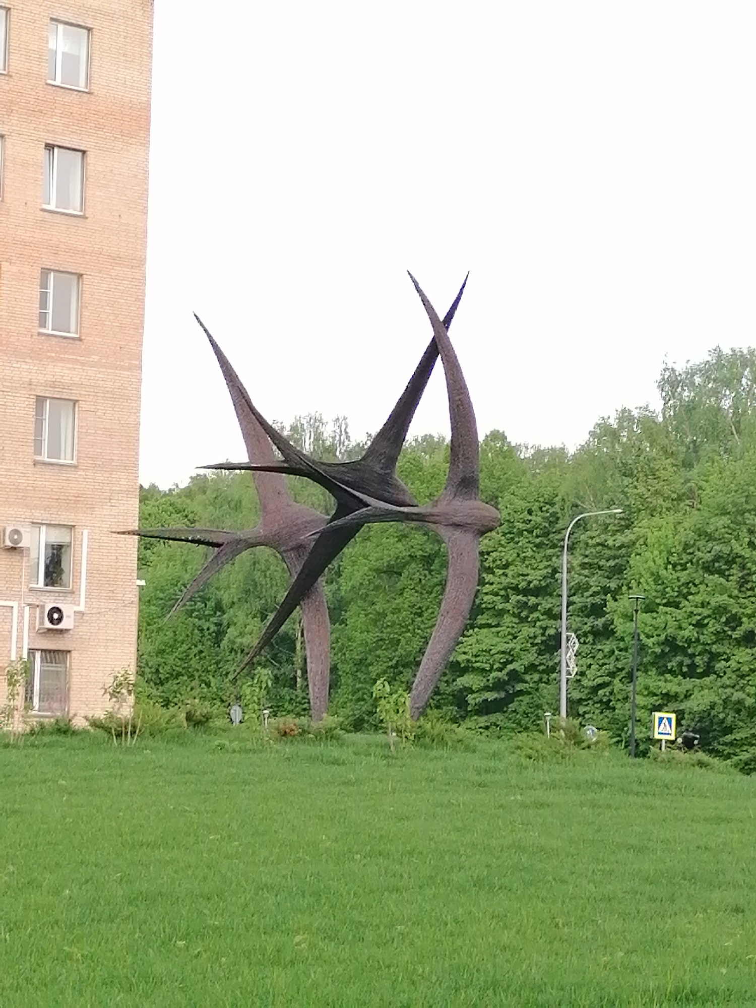 Visitor documents afternoon stroll through urban park with sculptures, fountains