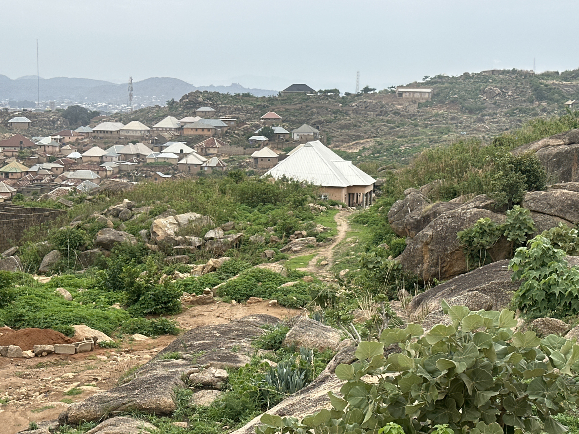 Residential construction activity documented in rocky Jos, Nigeria neighborhood