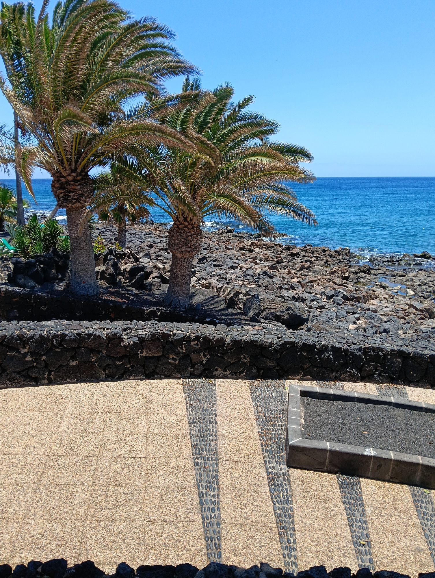 Tourist captures sunny afternoon stroll through Puerto Del Carmen coastline
