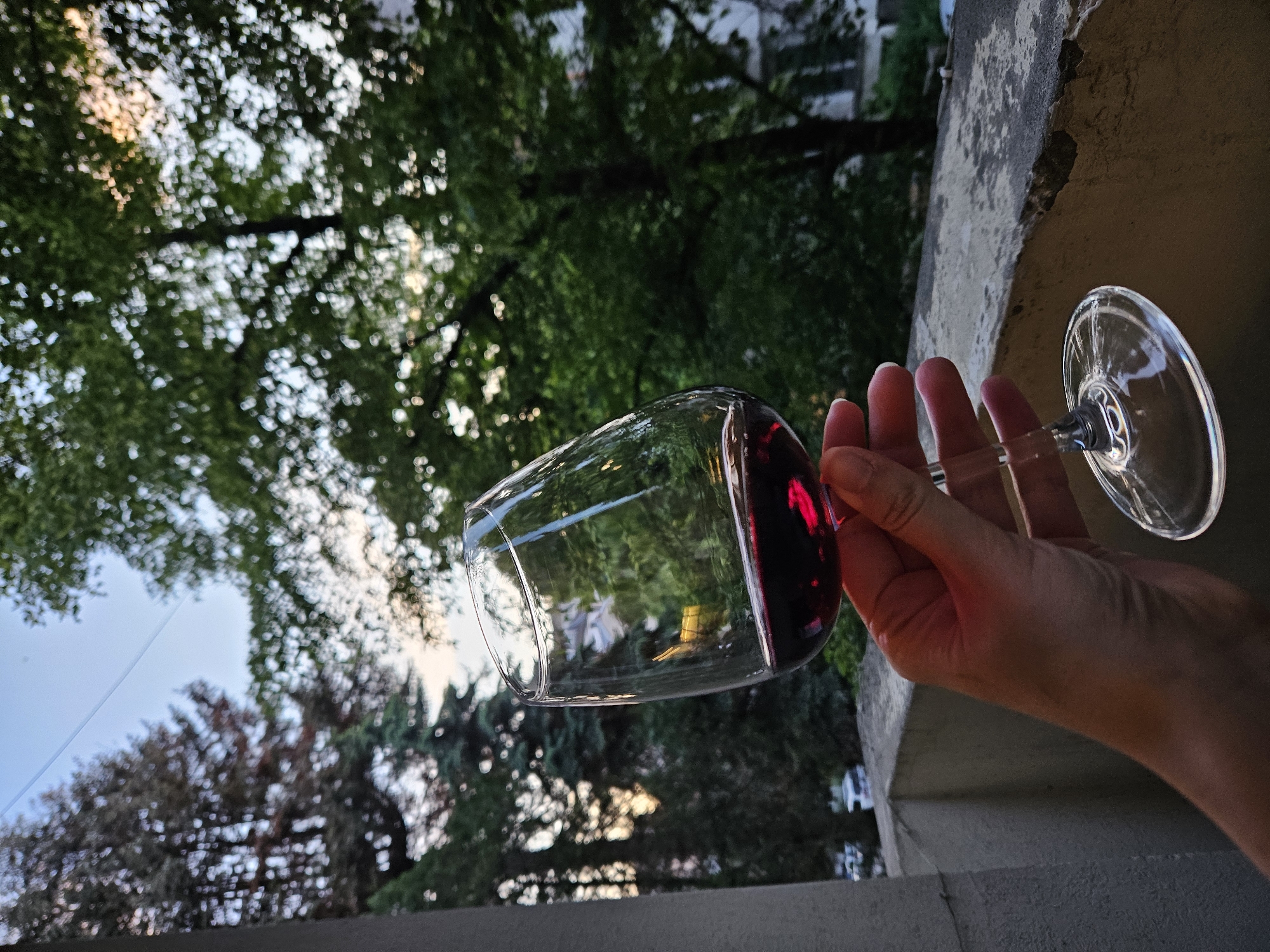 Wine glass held outdoors in Sofia balcony setting