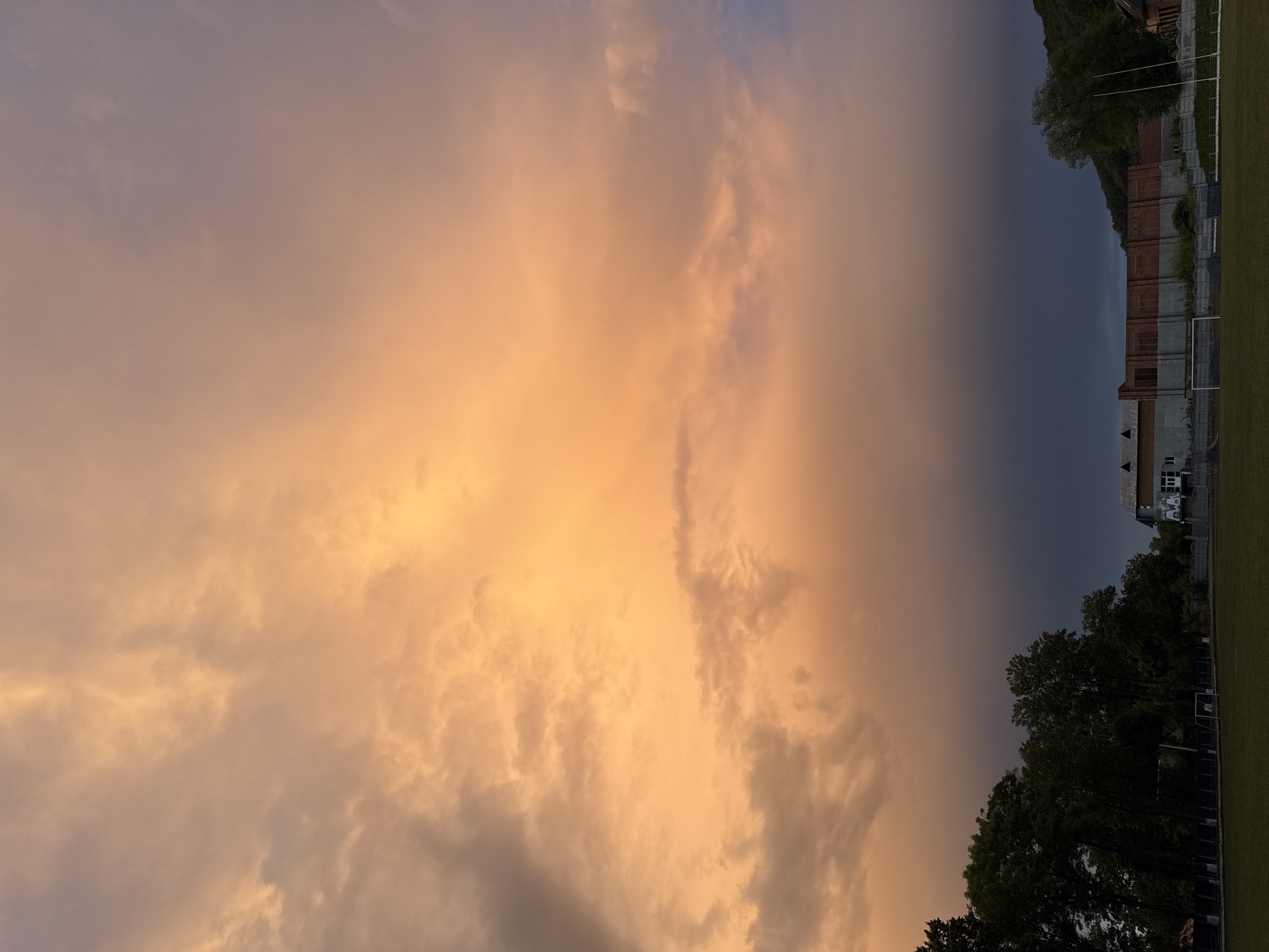 Sunset clouds over a forested stadium, multiple angles