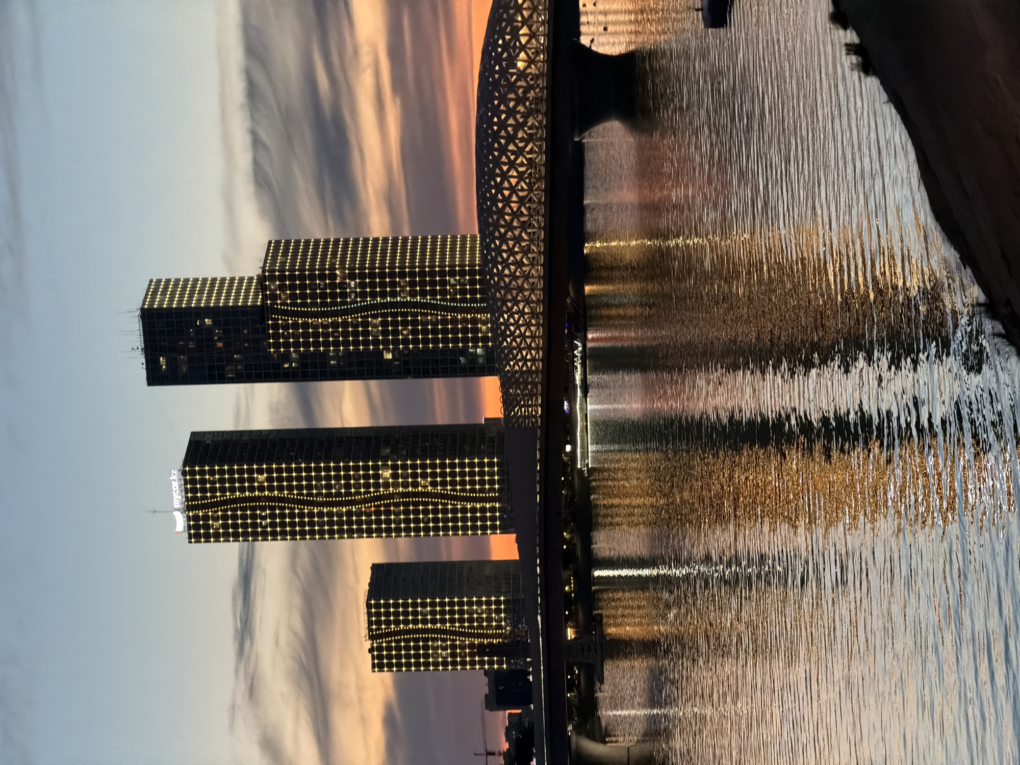Astana skyline and waterfront illuminated at twilight