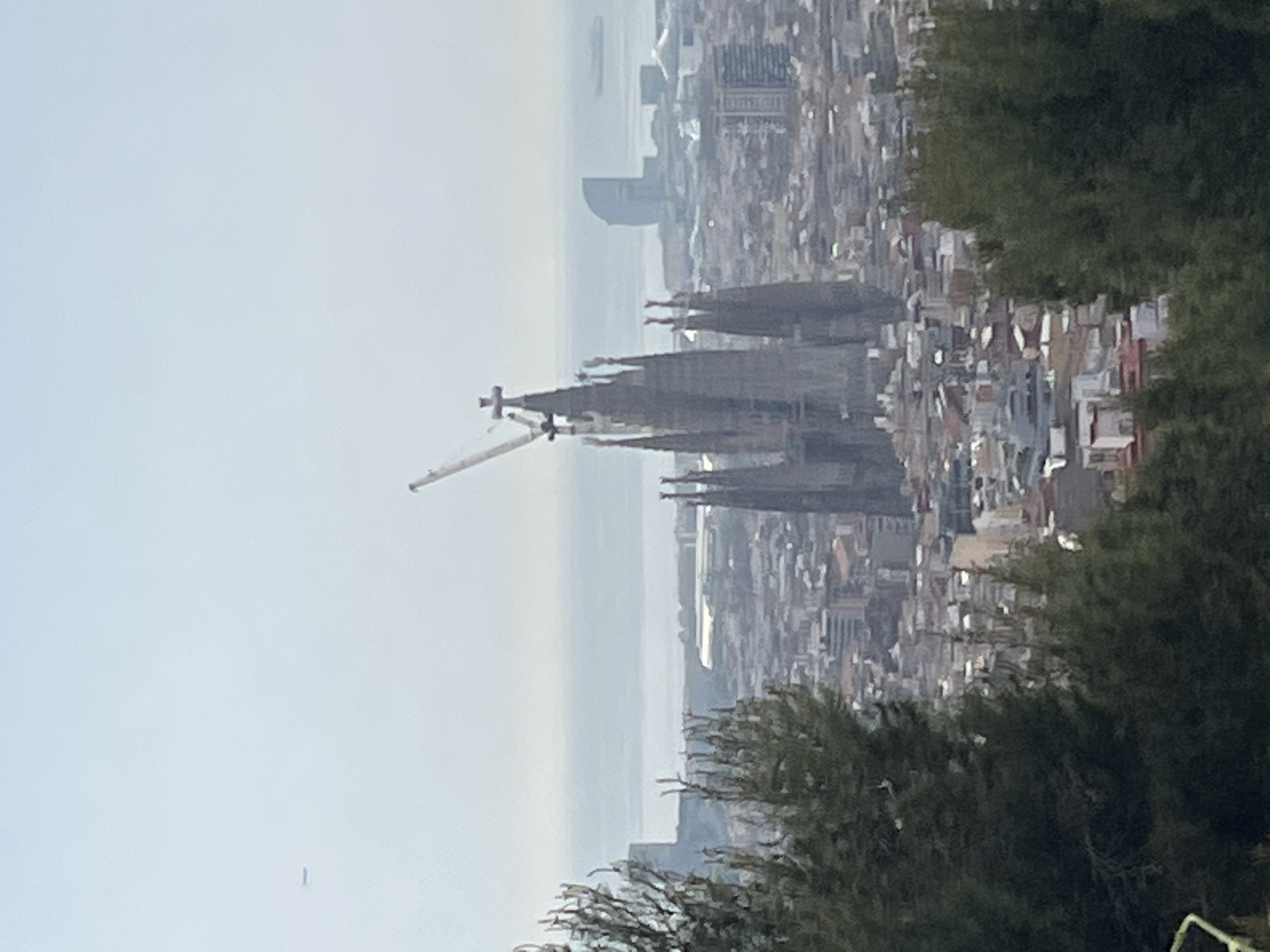 Barcelona panoramic view captured showing Sagrada Familia under hazy skies