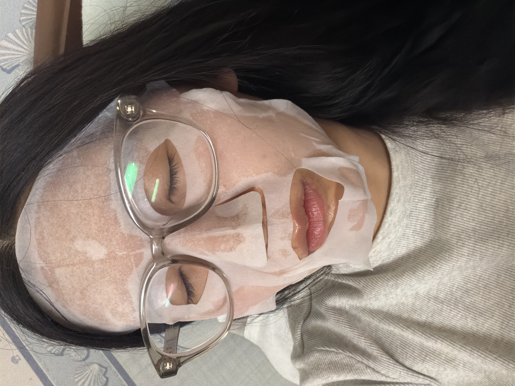 Woman uses facial sheet mask in Kawasaki