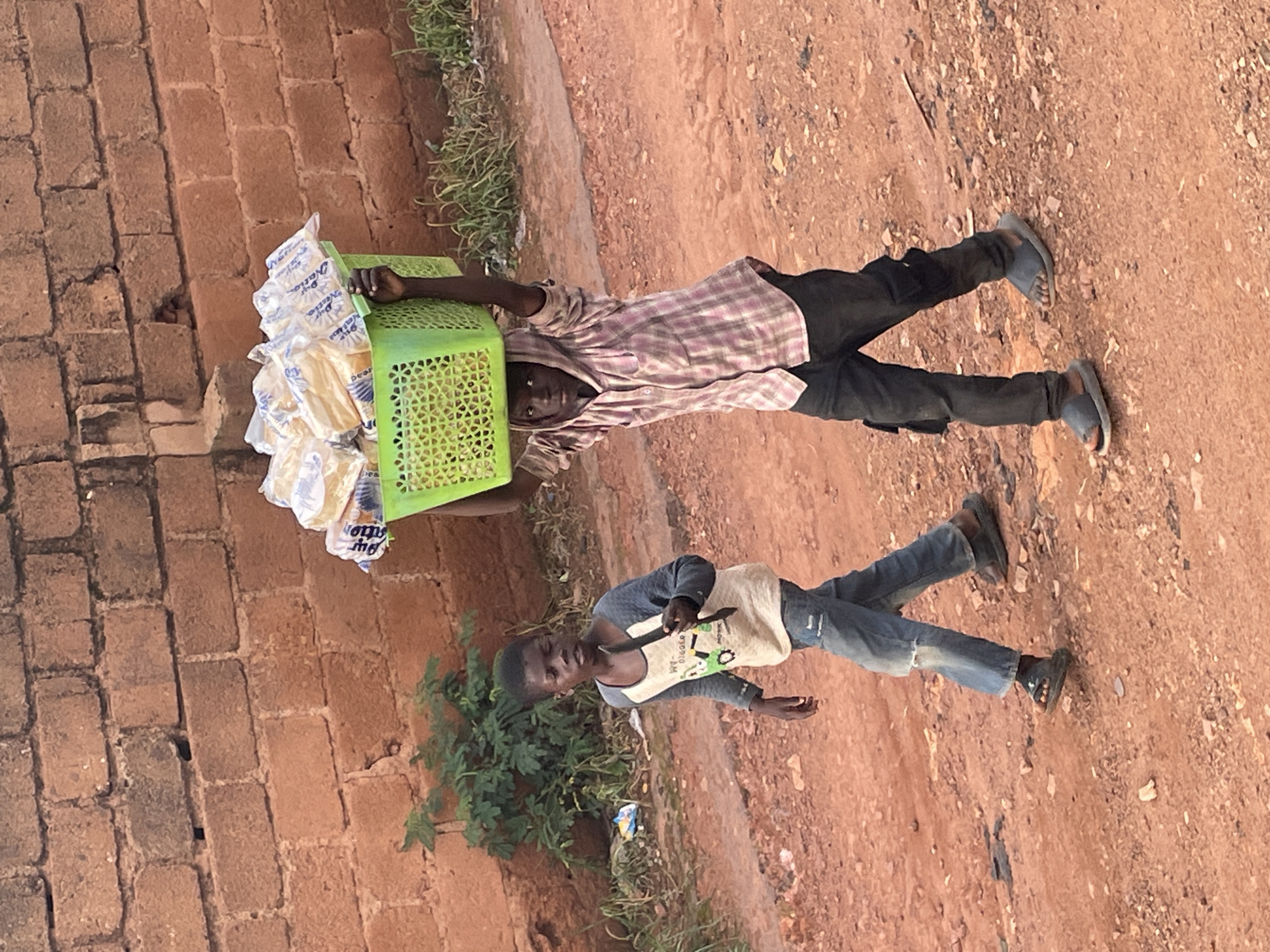 Pickup football and street life on a dusty Jos afternoon