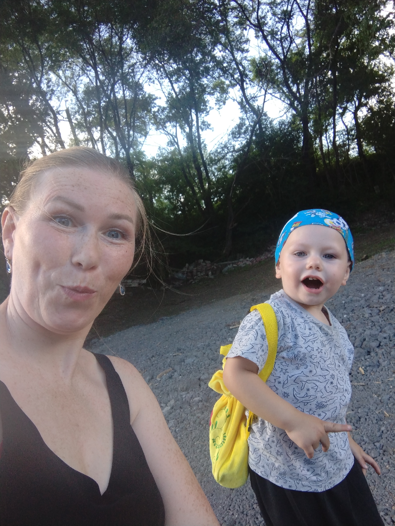 Casual outdoor selfies at a rocky, tree-lined spot