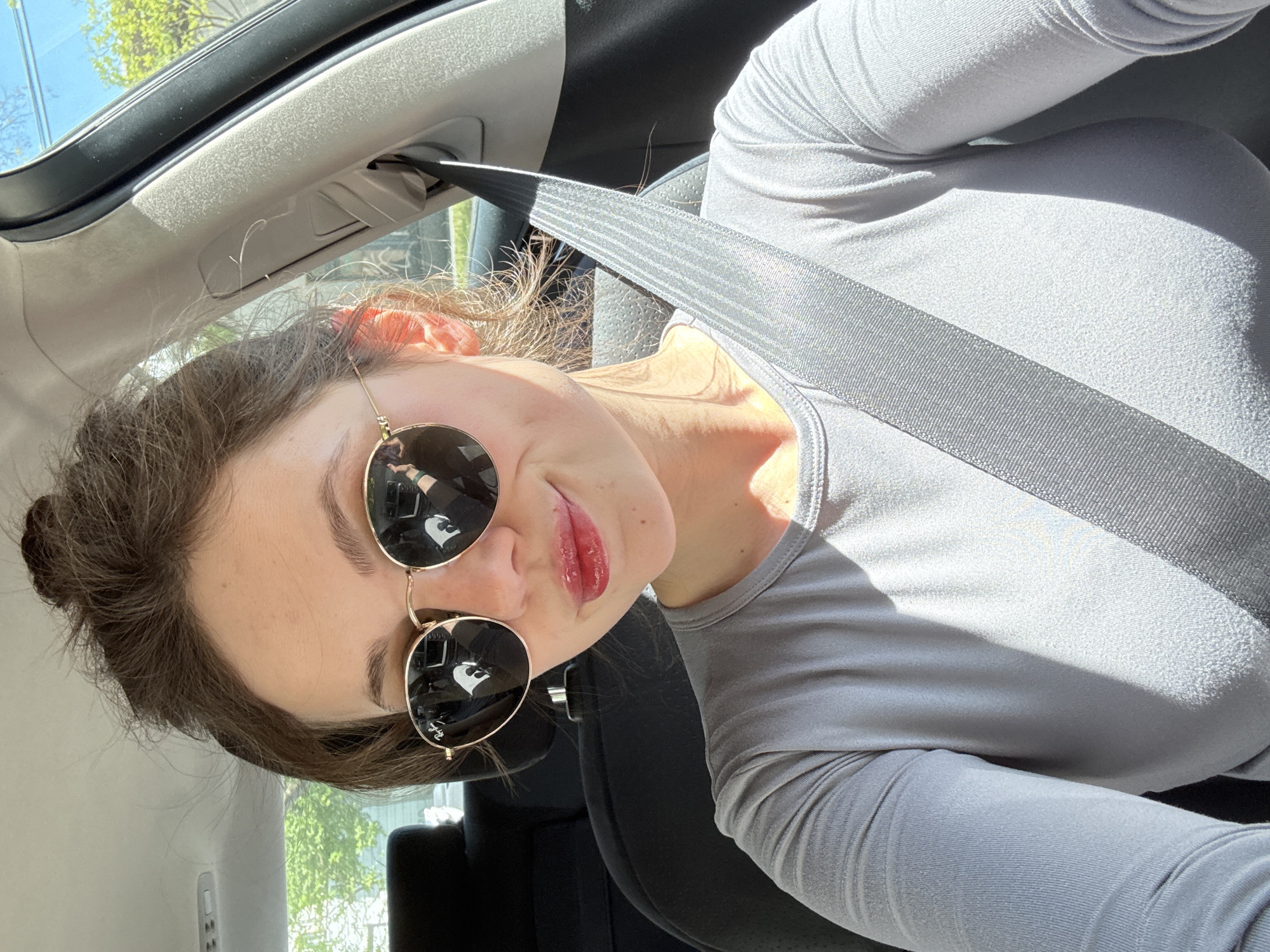 Woman poses for photos in car during daytime Budapest