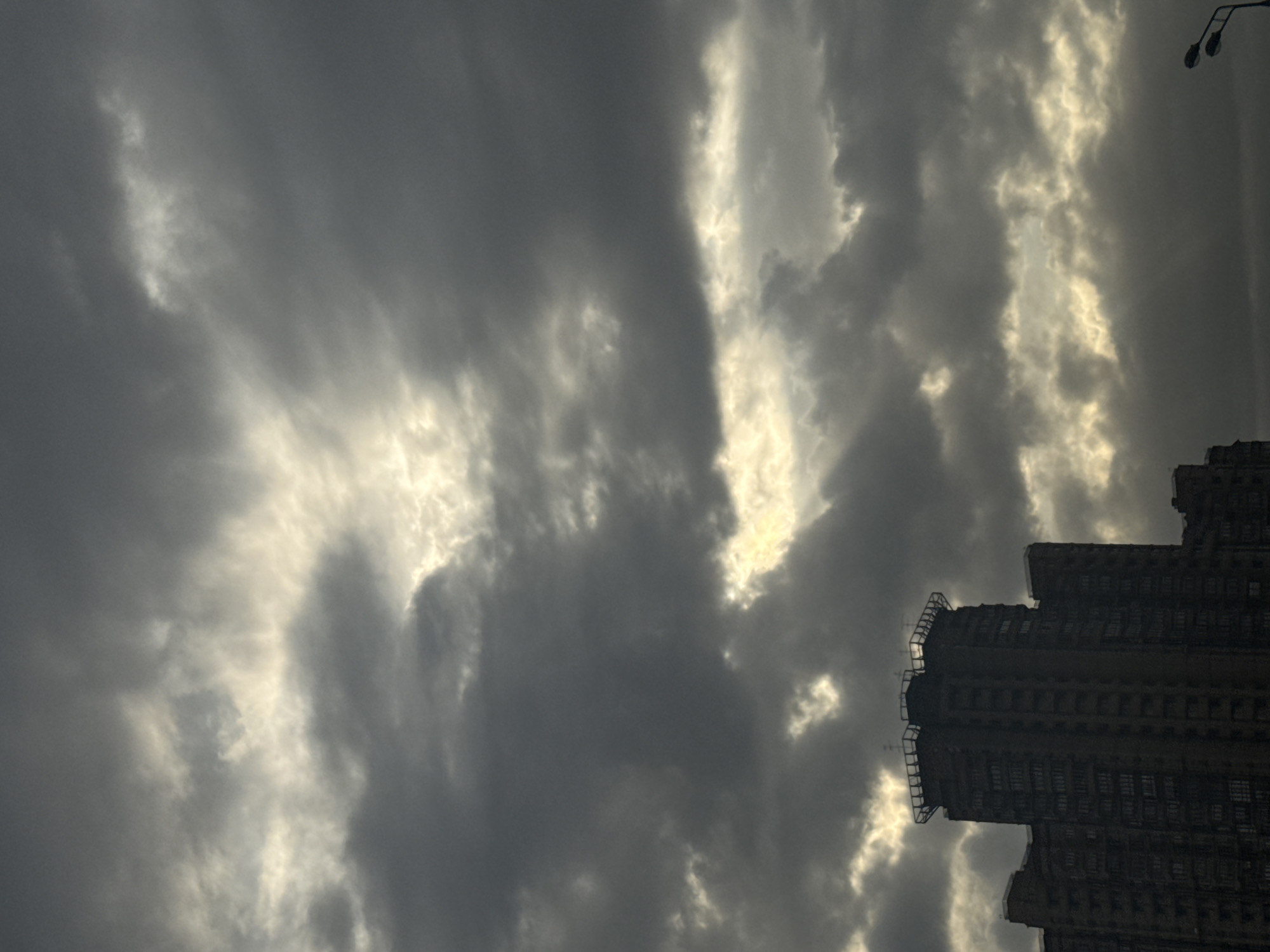 Dramatic clouds and sunlight create striking contrast over Moscow building