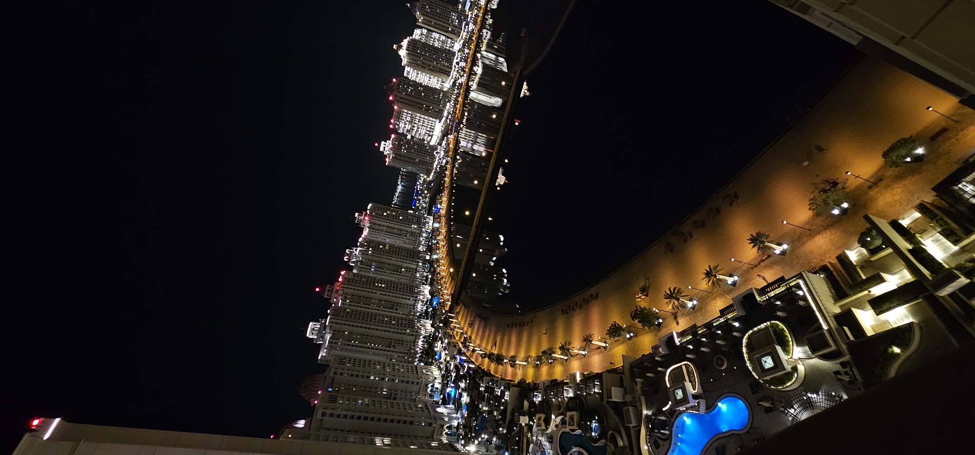 Night aerial of The Pearl-Qatar's glowing waterfront promenade