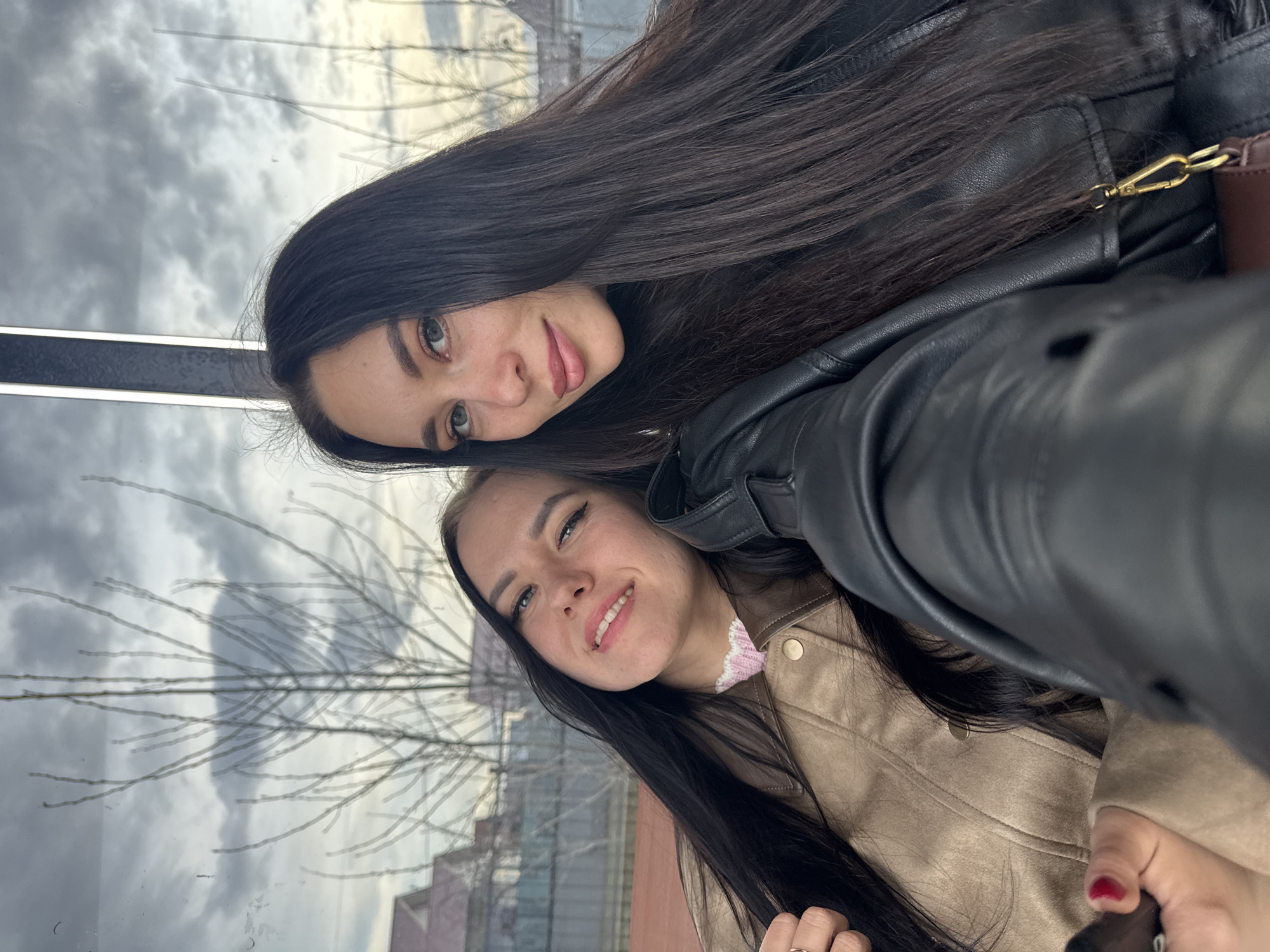 Young women take selfies by Kama River in Chaikovsky