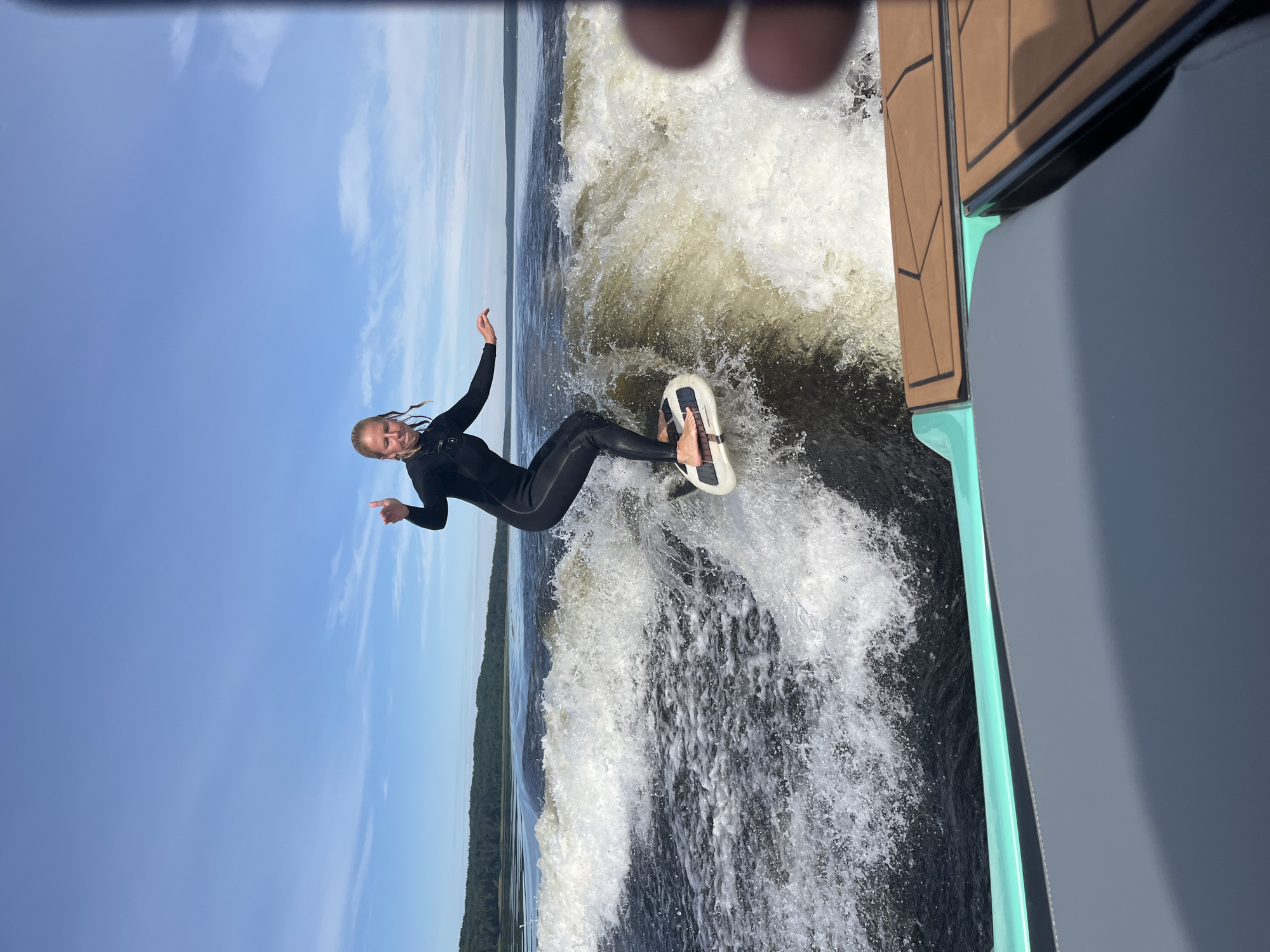 Wakesurfing behind a boat on a Russian lake