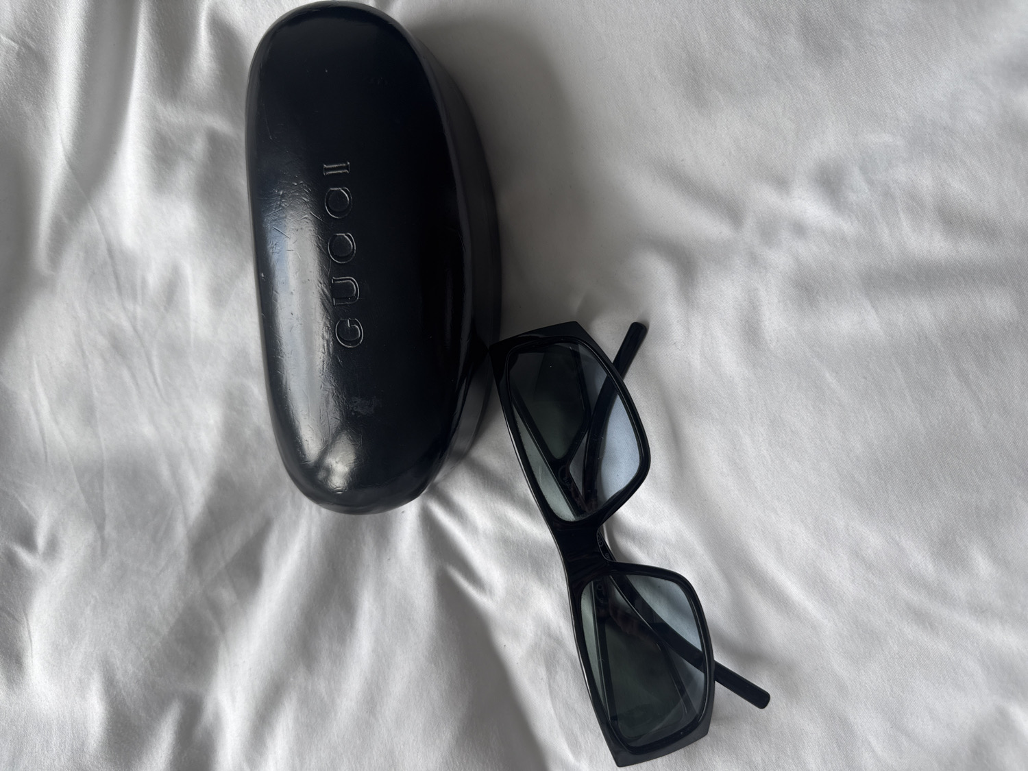 Sunglasses photographed on white fabric surface in London