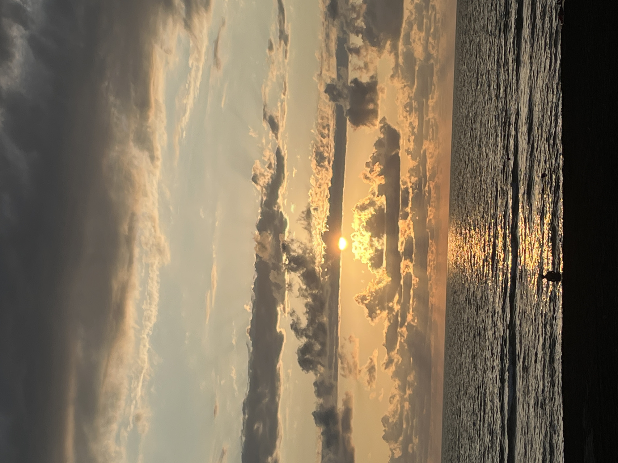 Sunset hour on Ureki's black sand beach promenade