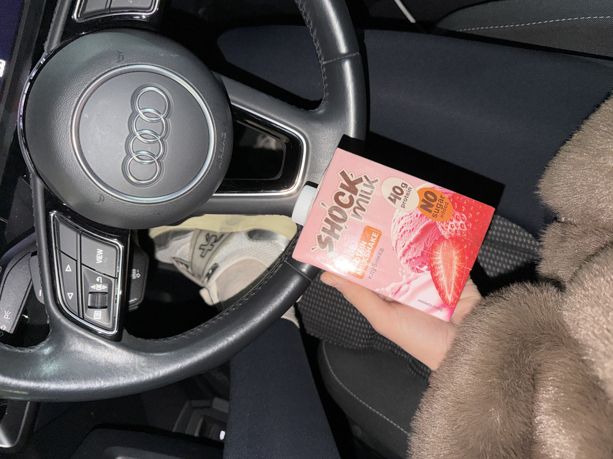 Driver holds strawberry protein shake in Audi, Krasnoyarsk