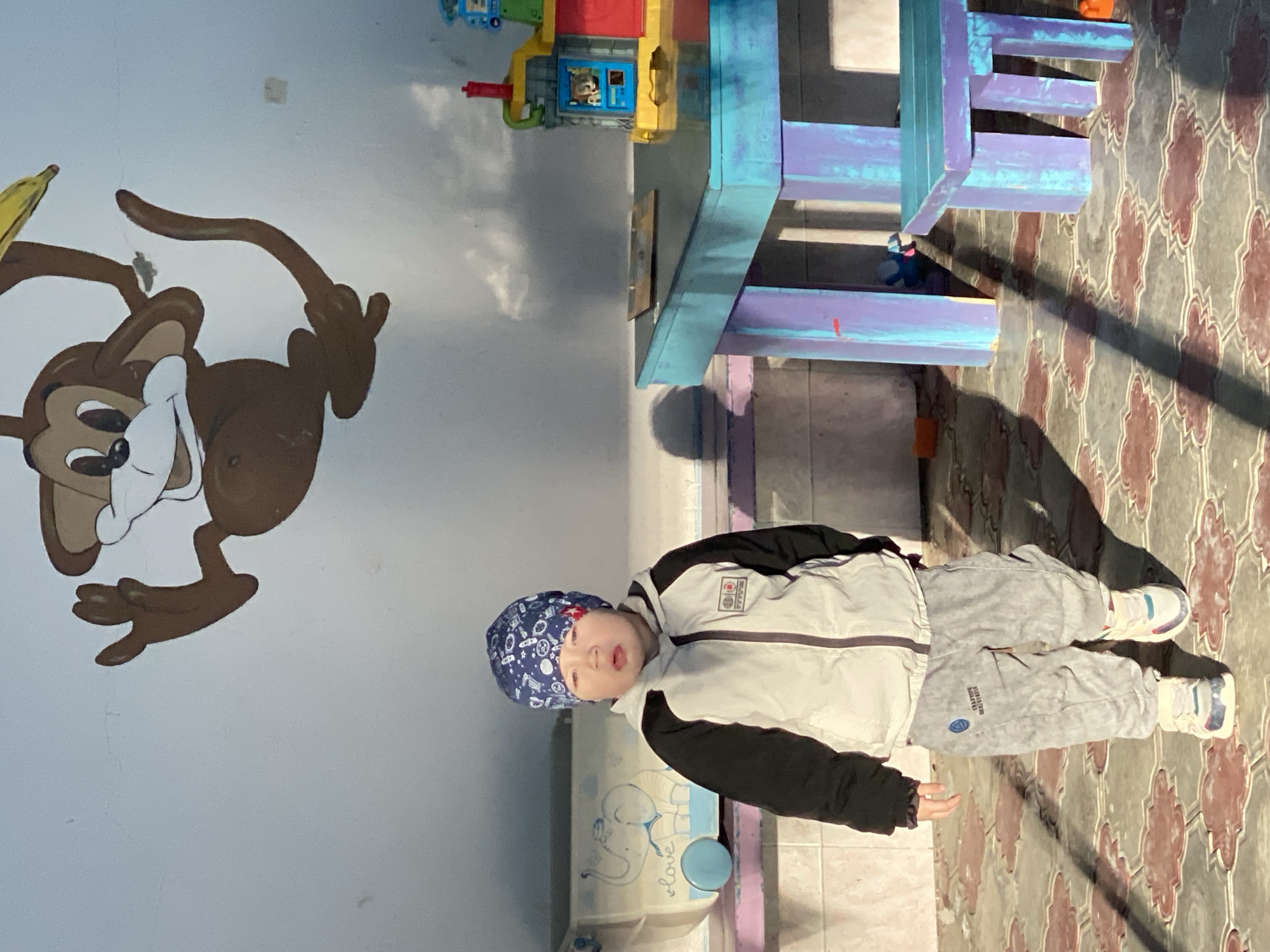 Child plays at indoor facility, walks stairs in Sochi