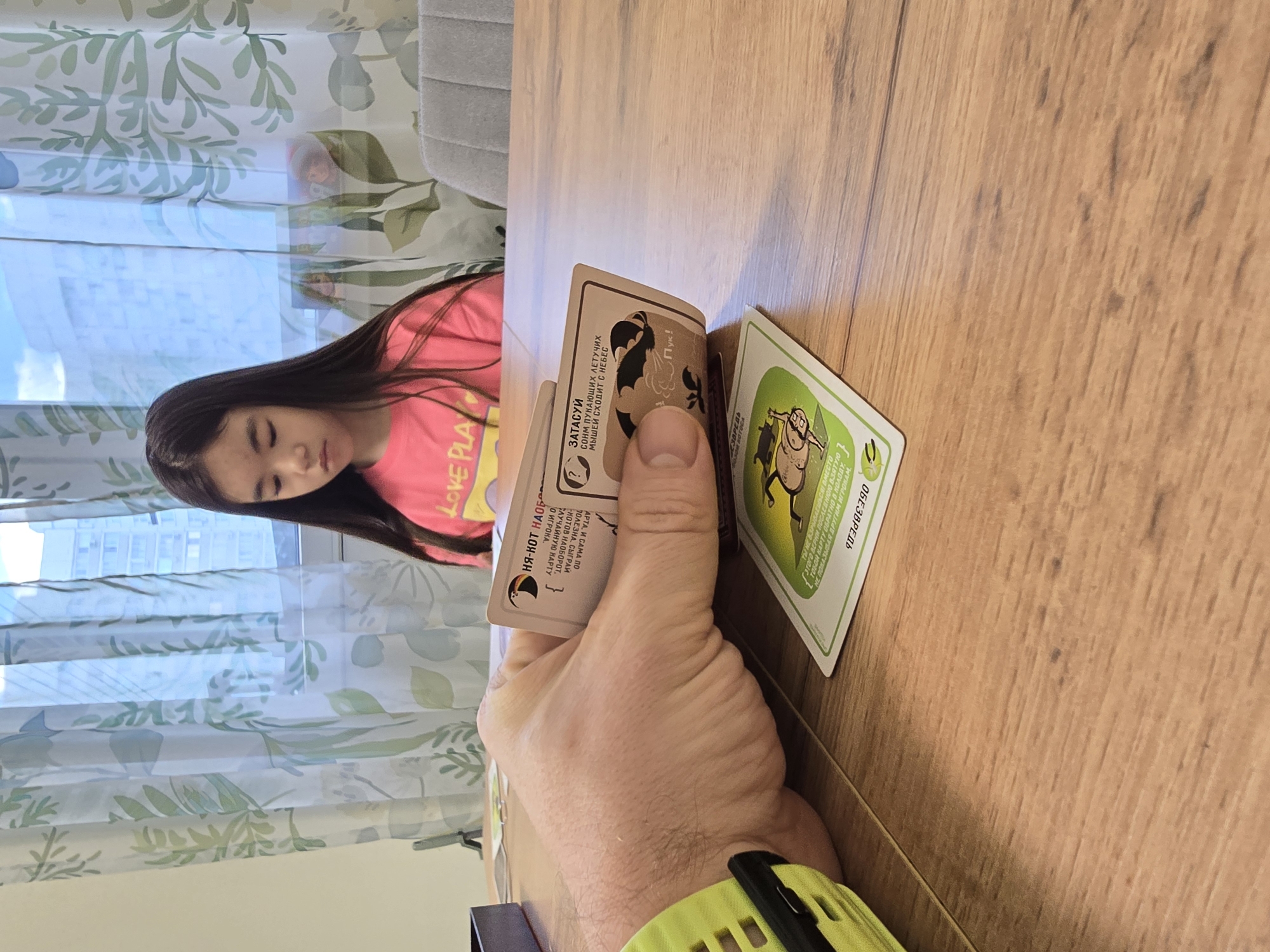 Card game and window views documented in Khimki apartment