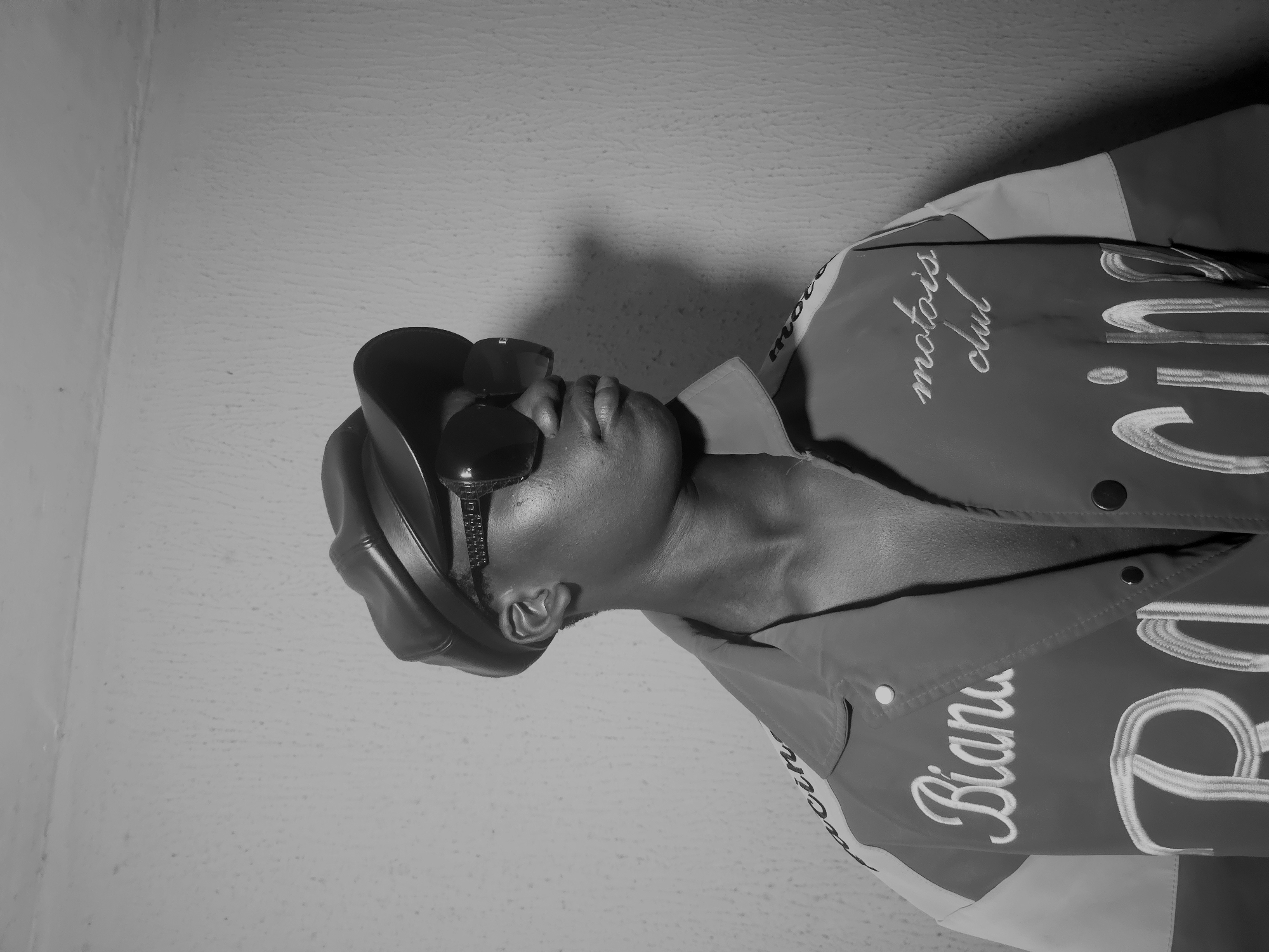 Person in racing jacket photographed indoors in Nkwelle, Nigeria