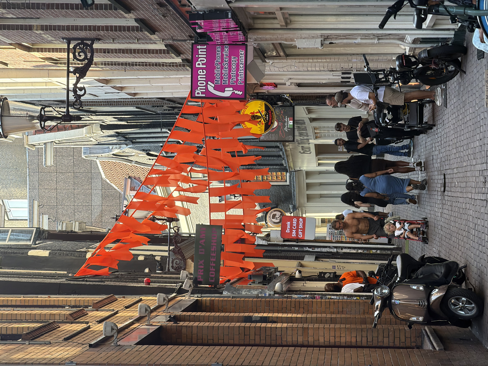 Amsterdam streets buzzing under orange flags on a June afternoon