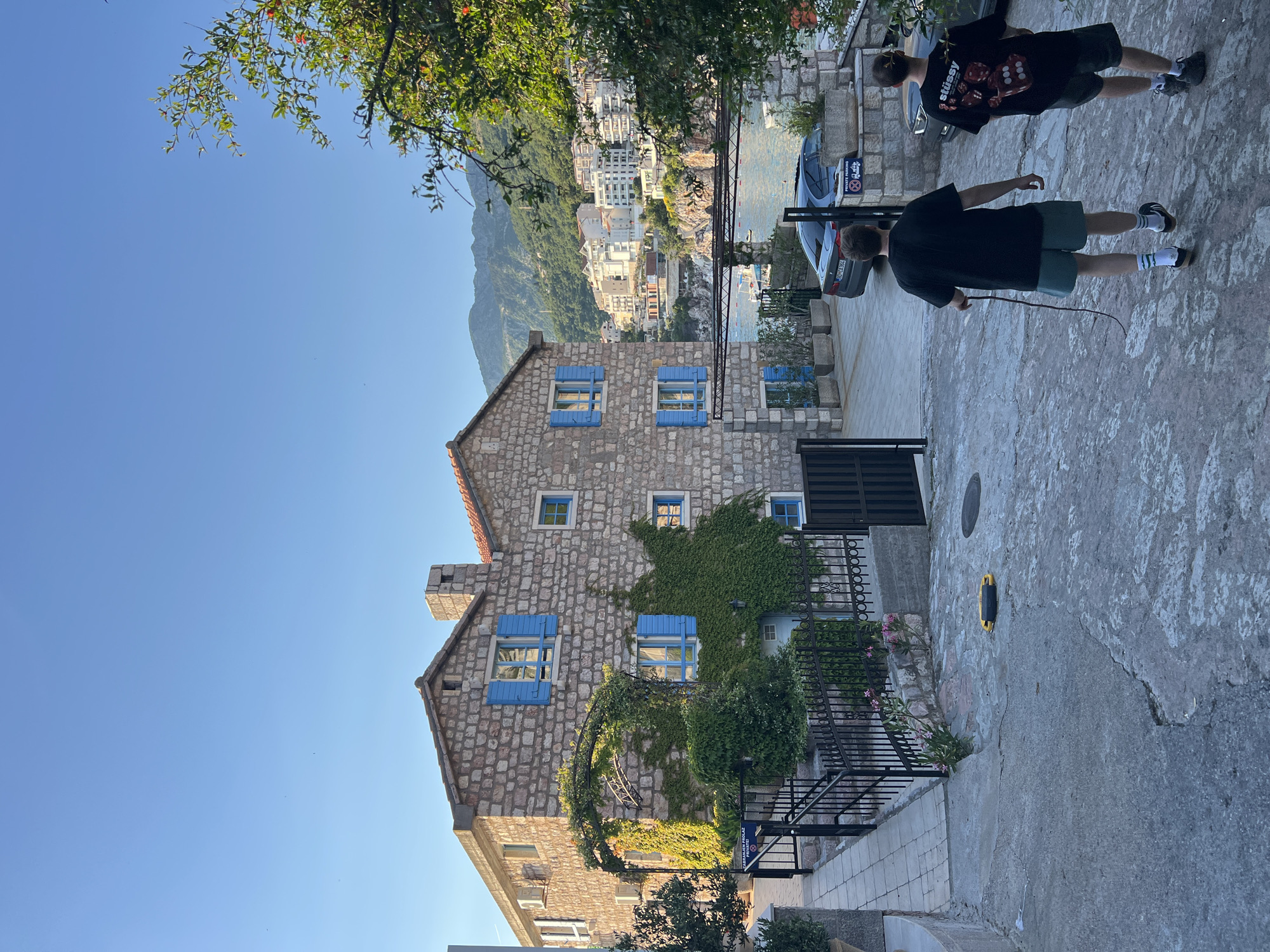 Stone building with blue shutters observed in Pržno, Montenegro