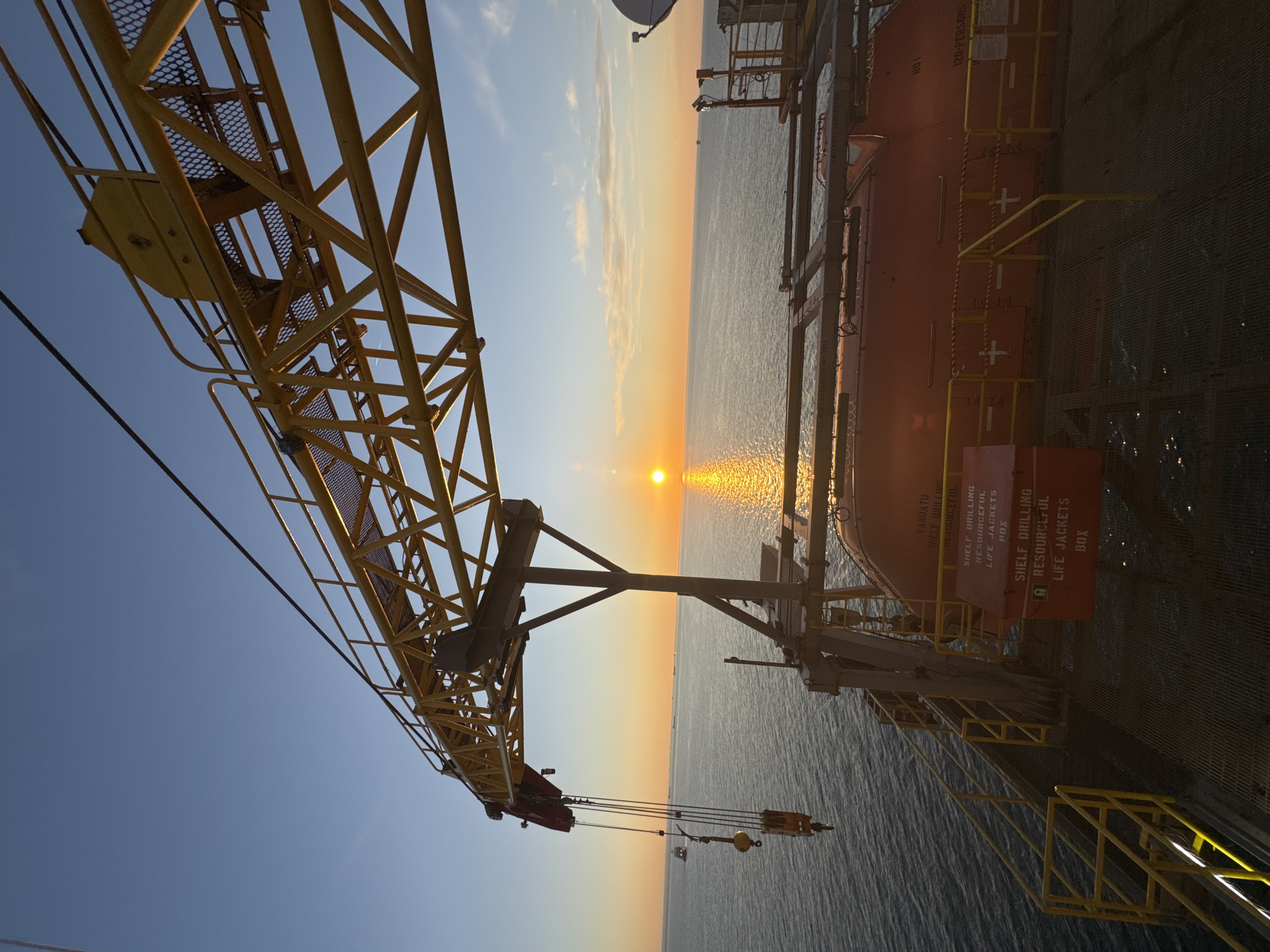 Offshore worker documents sunset from Italian industrial platform