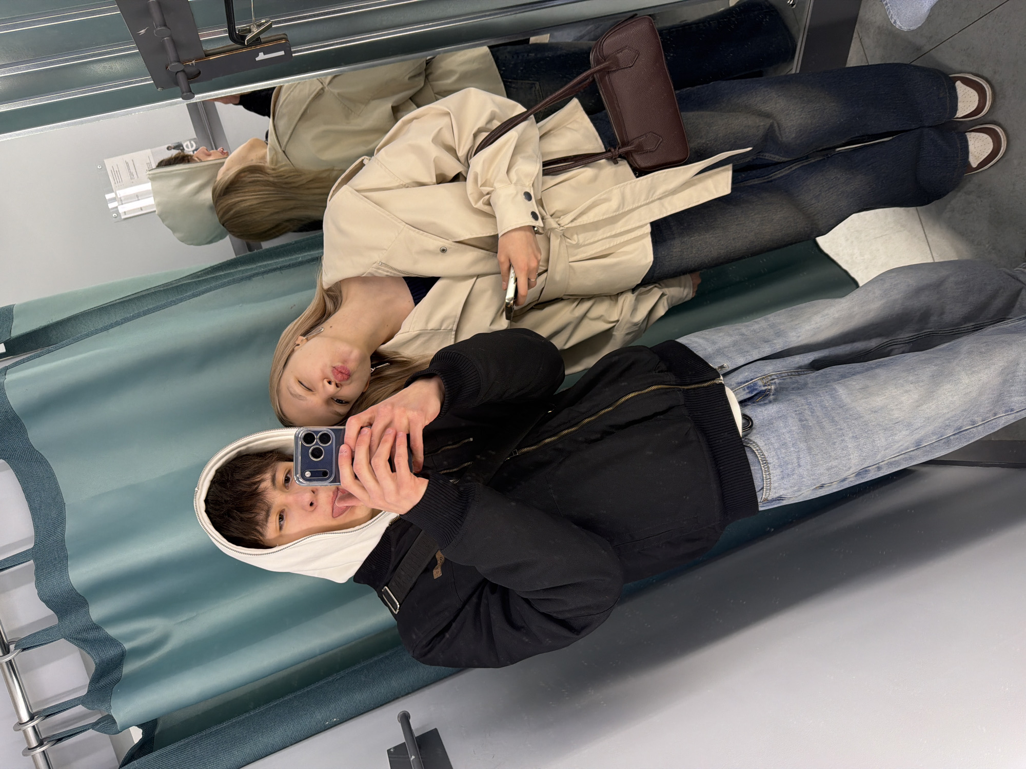 Two youths take mirror selfie in Yekaterinburg fitting room