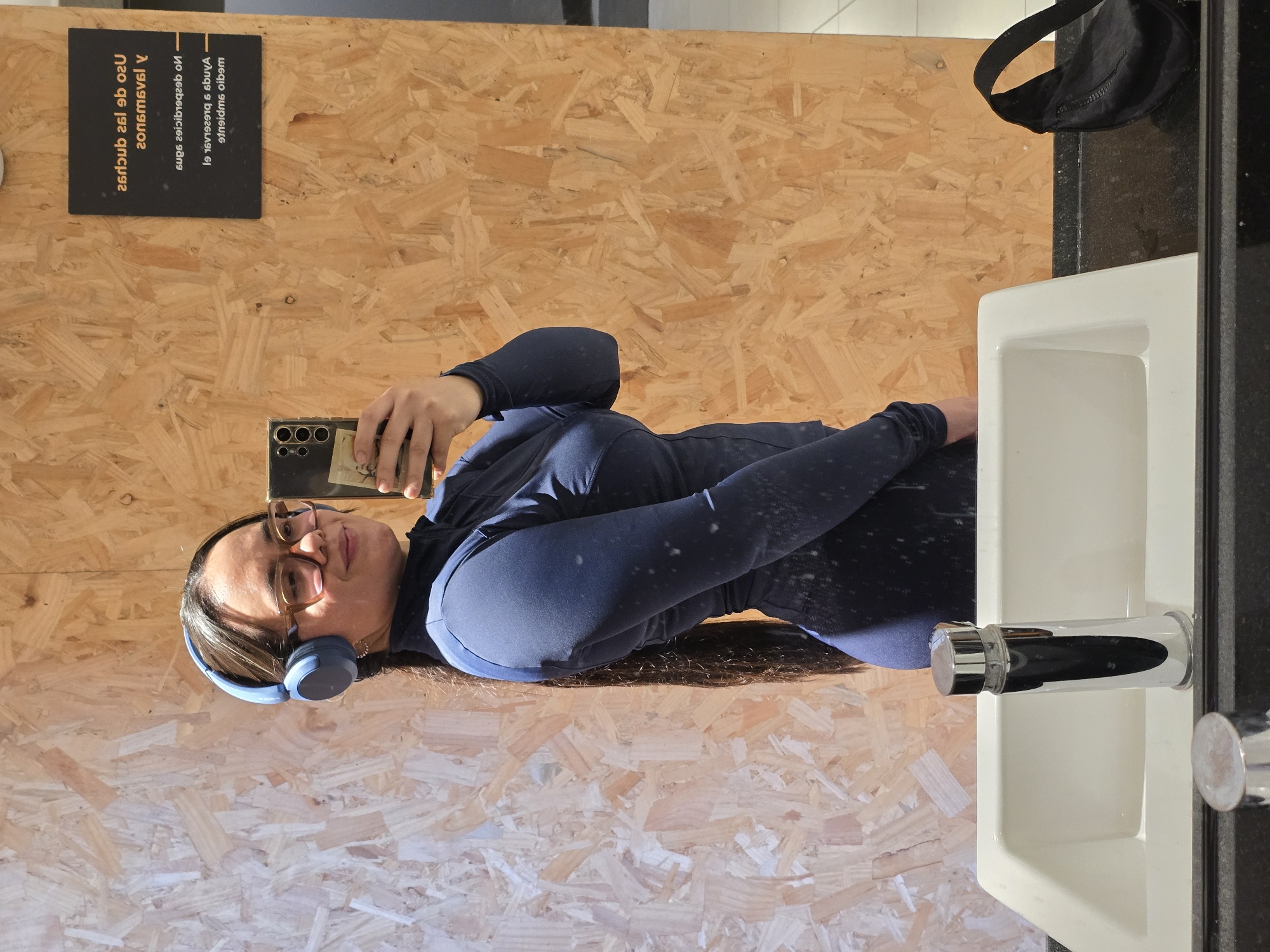 Woman takes selfie in public restroom in Puente Alto