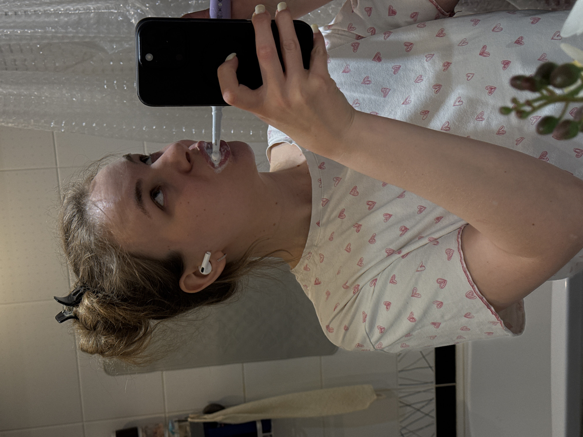 Woman records selfie while brushing teeth in Vladimir bathroom