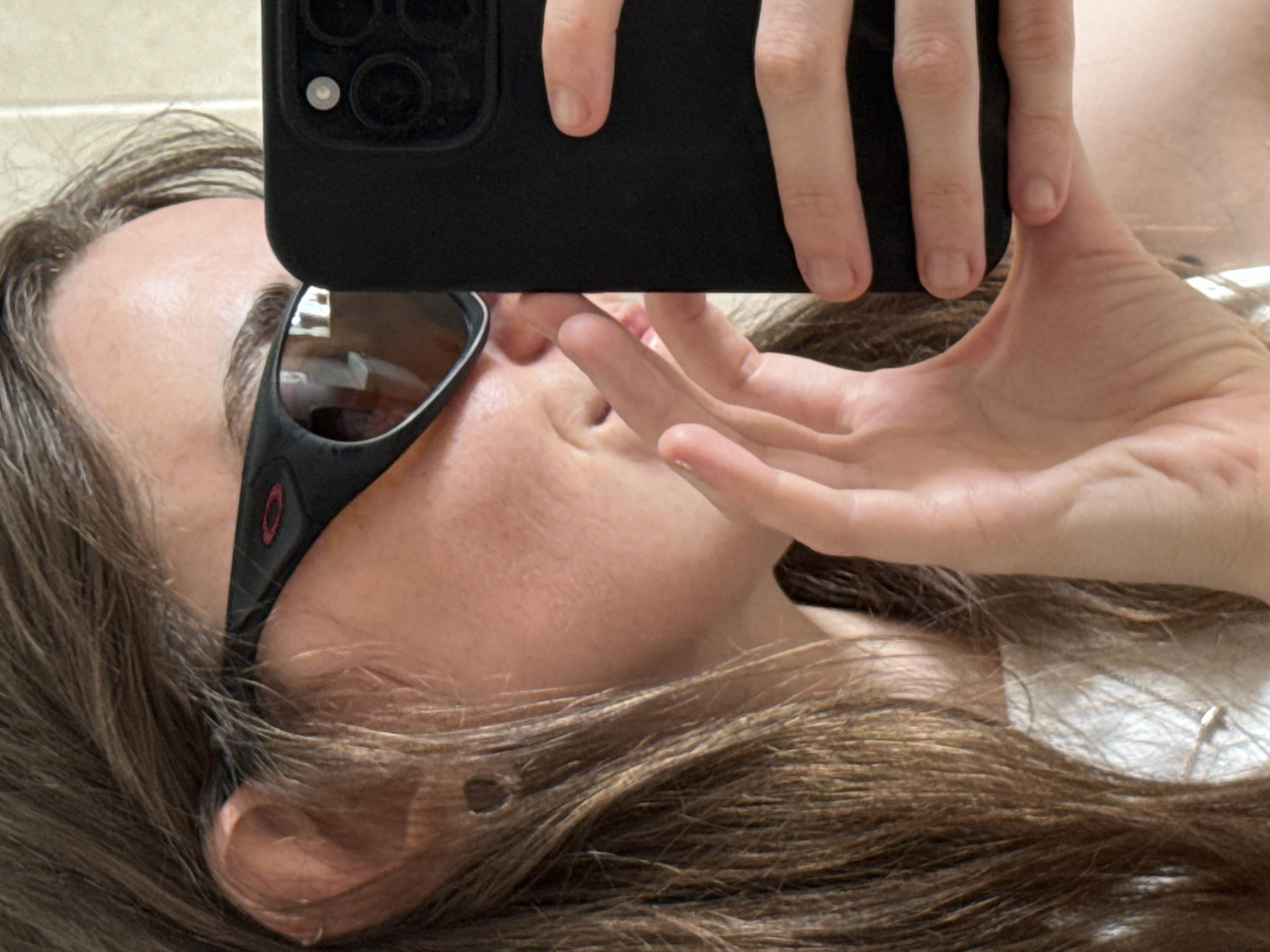 Upside-down selfie with Oakley shades in Ramat Gan