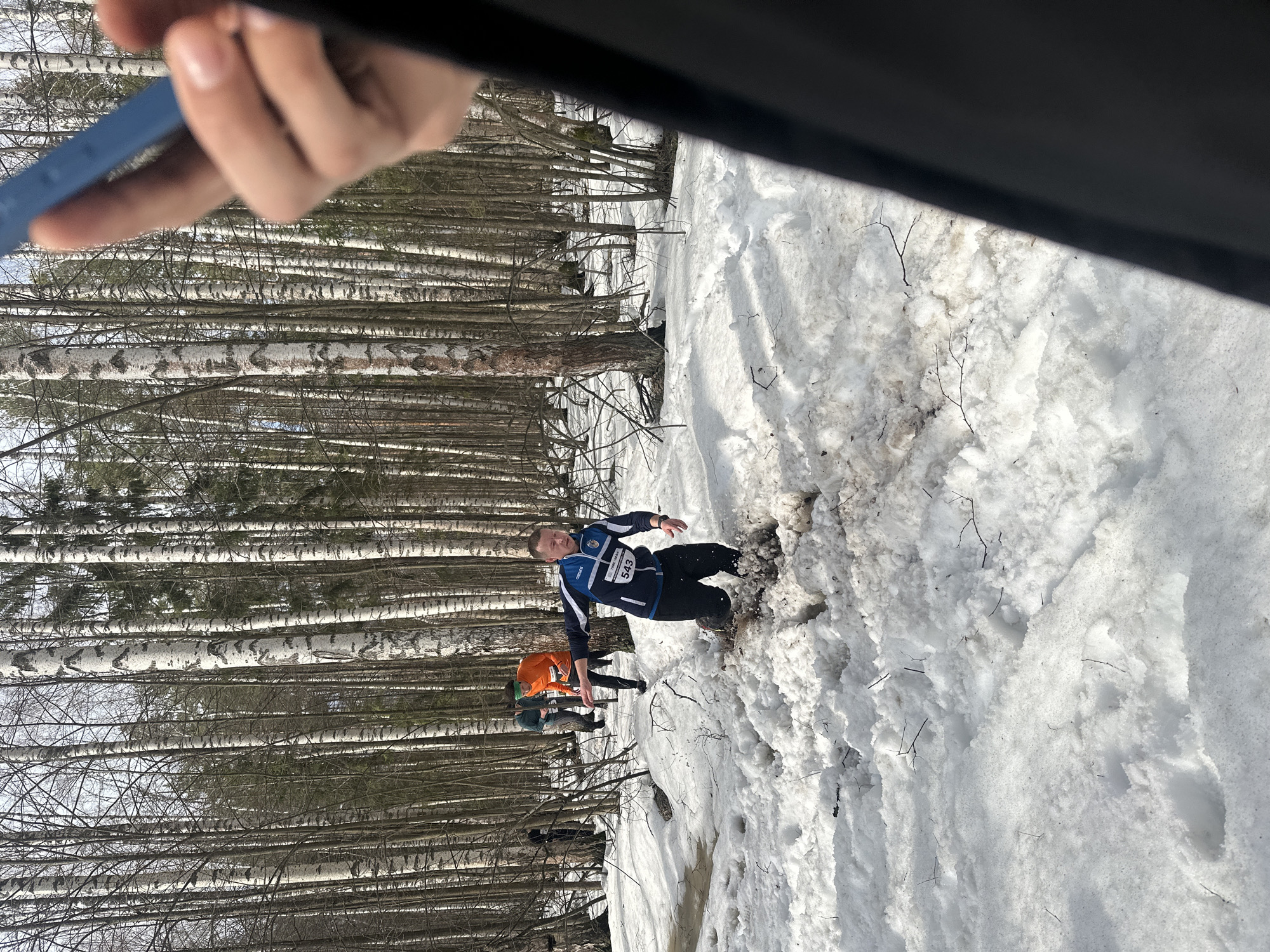Man in numbered jacket submerged in muddy snow near Zelenodol'sk