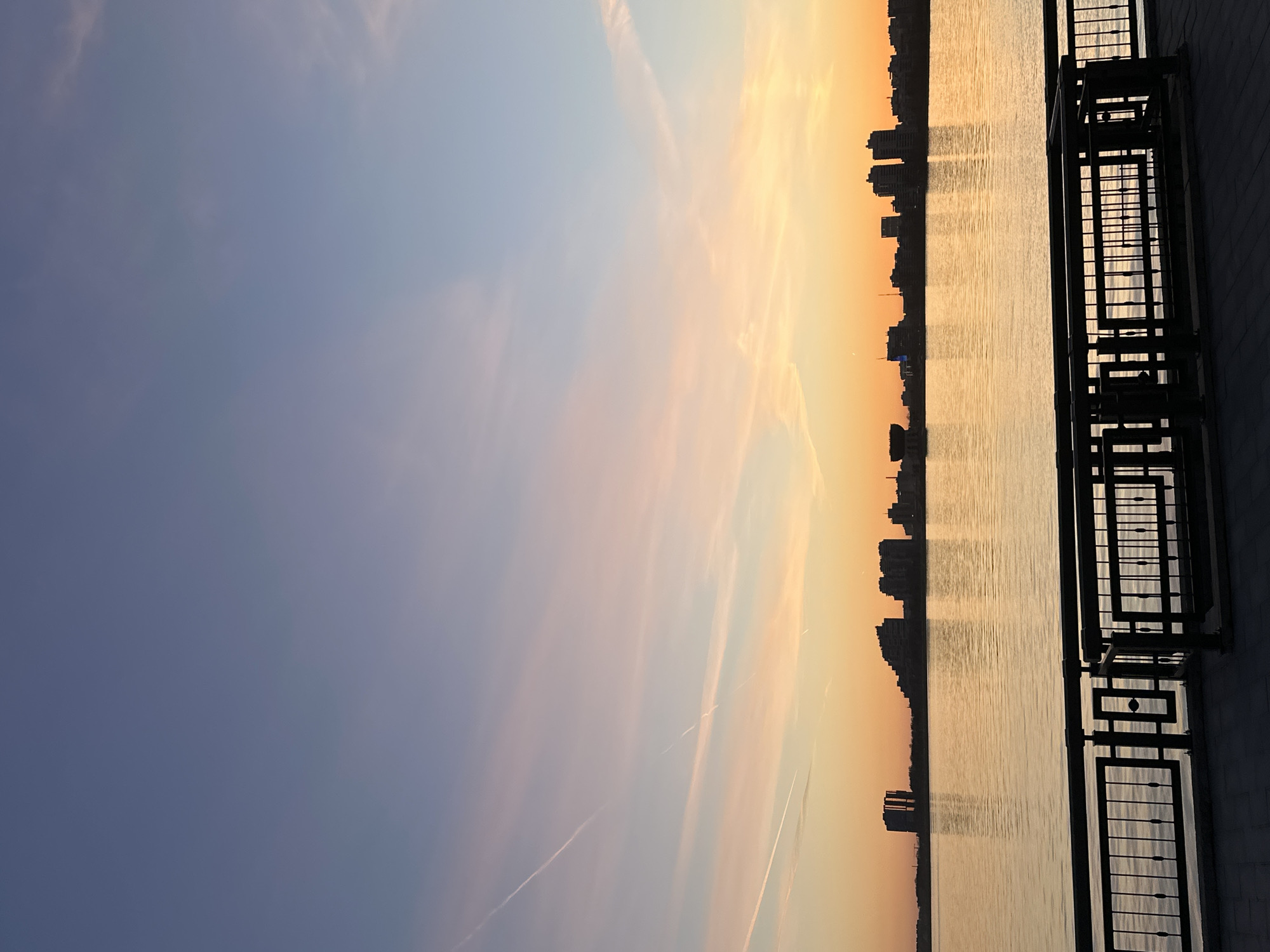 Young man poses on Kazan waterfront during sunset