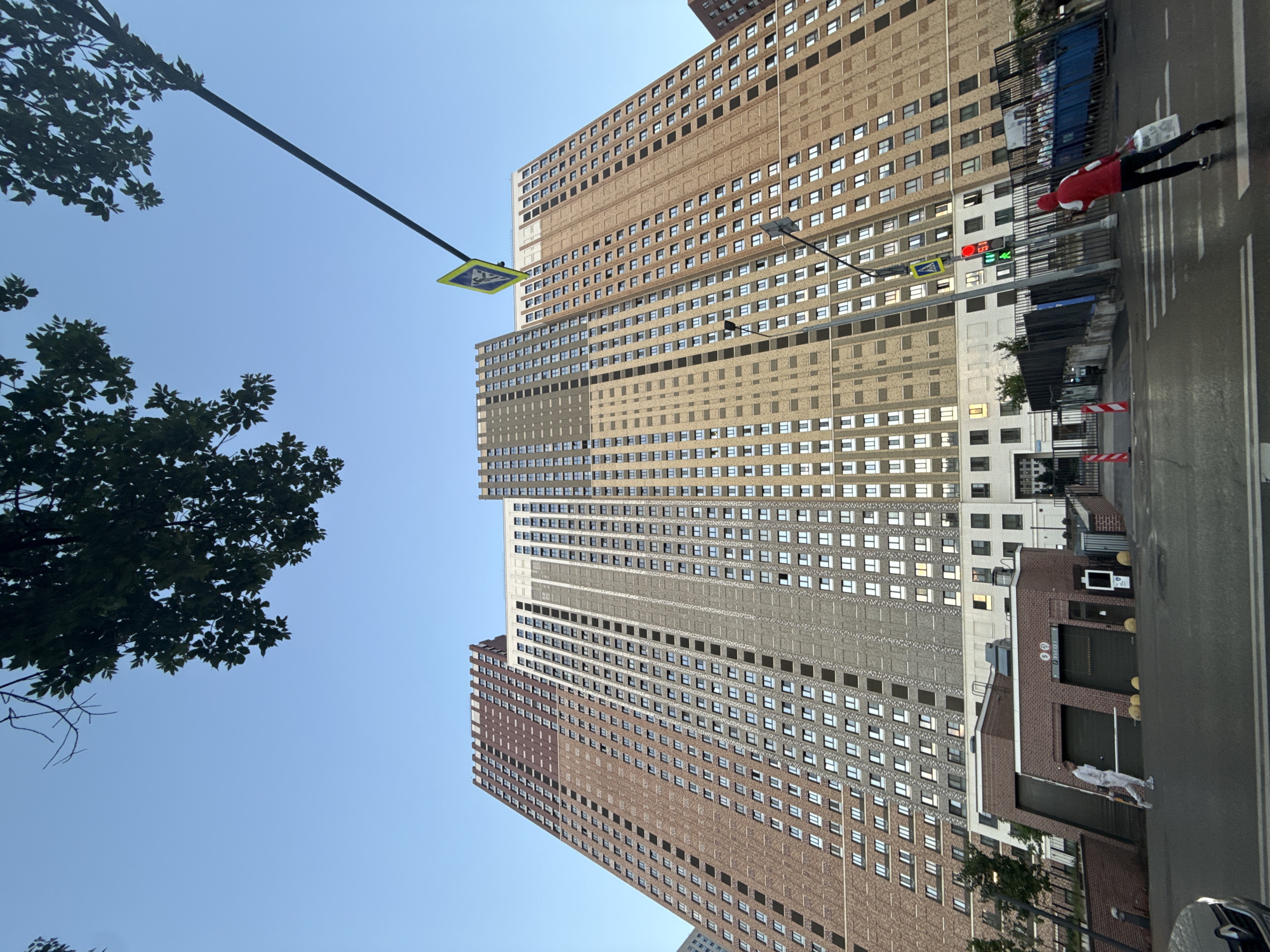 Tall brick residential tower rises against clear Moscow sky
