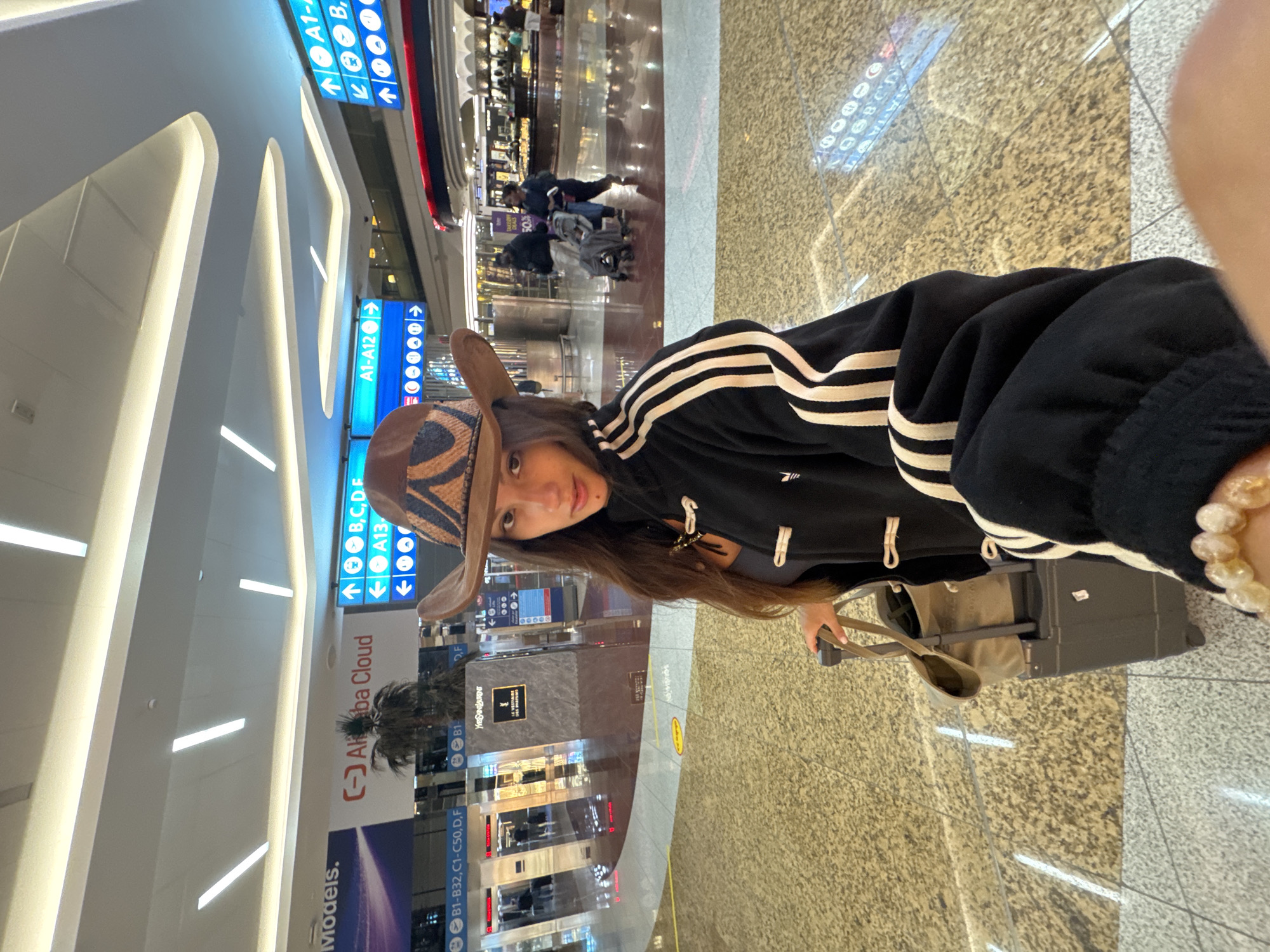 Cowboy hat and carry-on at Dubai International Airport