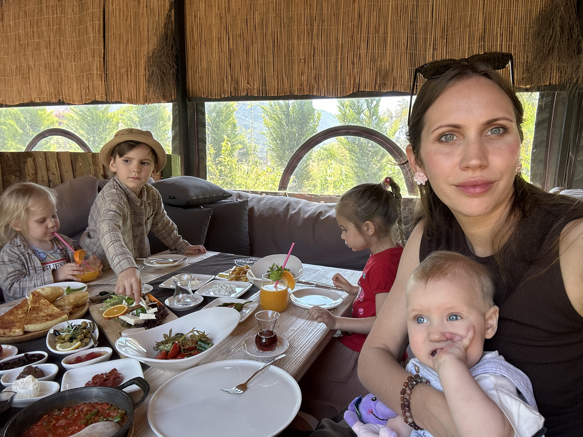Family enjoys morning breakfast at restaurant in Kaş, Turkey