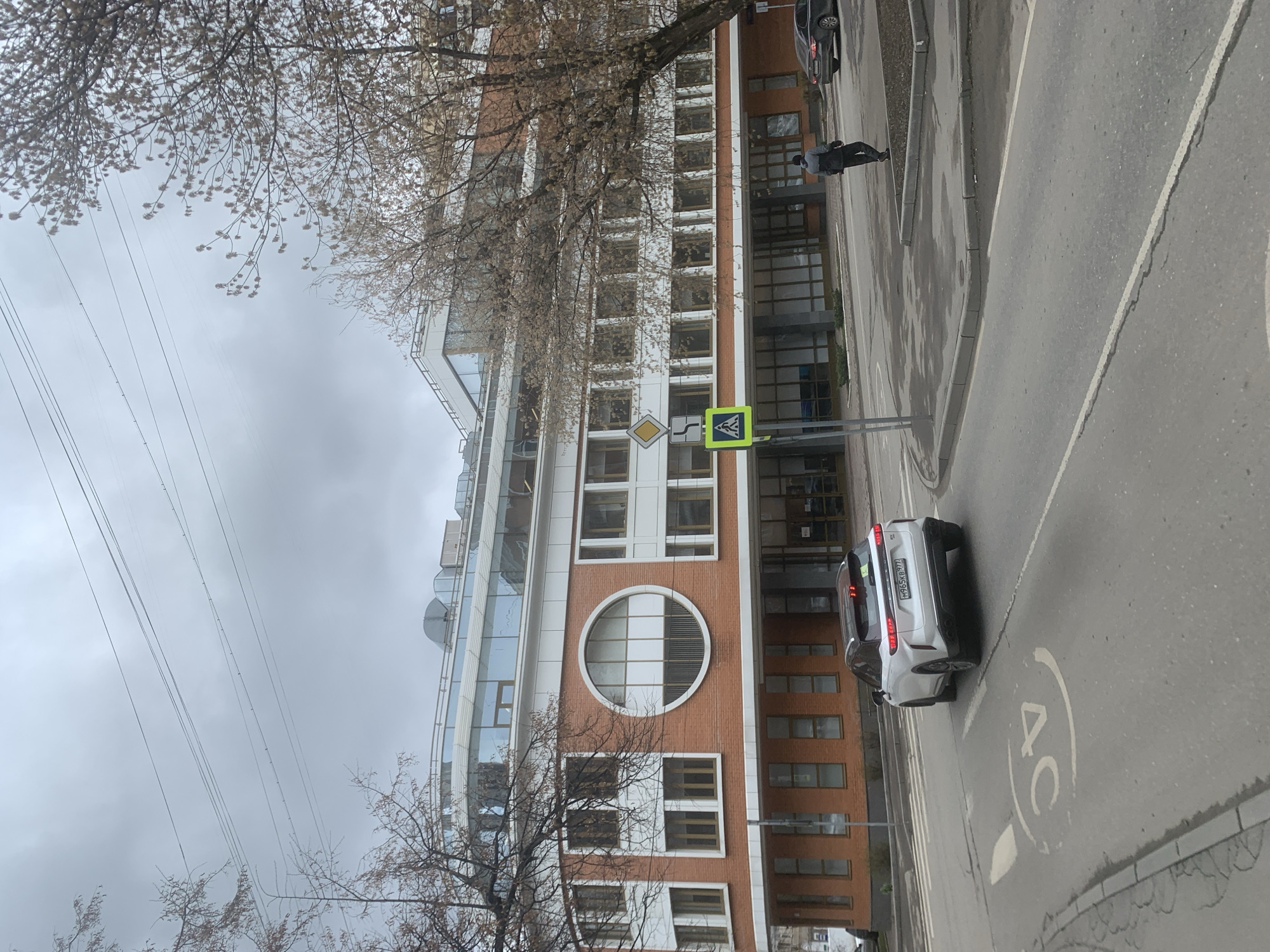 Woman and child walk Moscow street on overcast morning