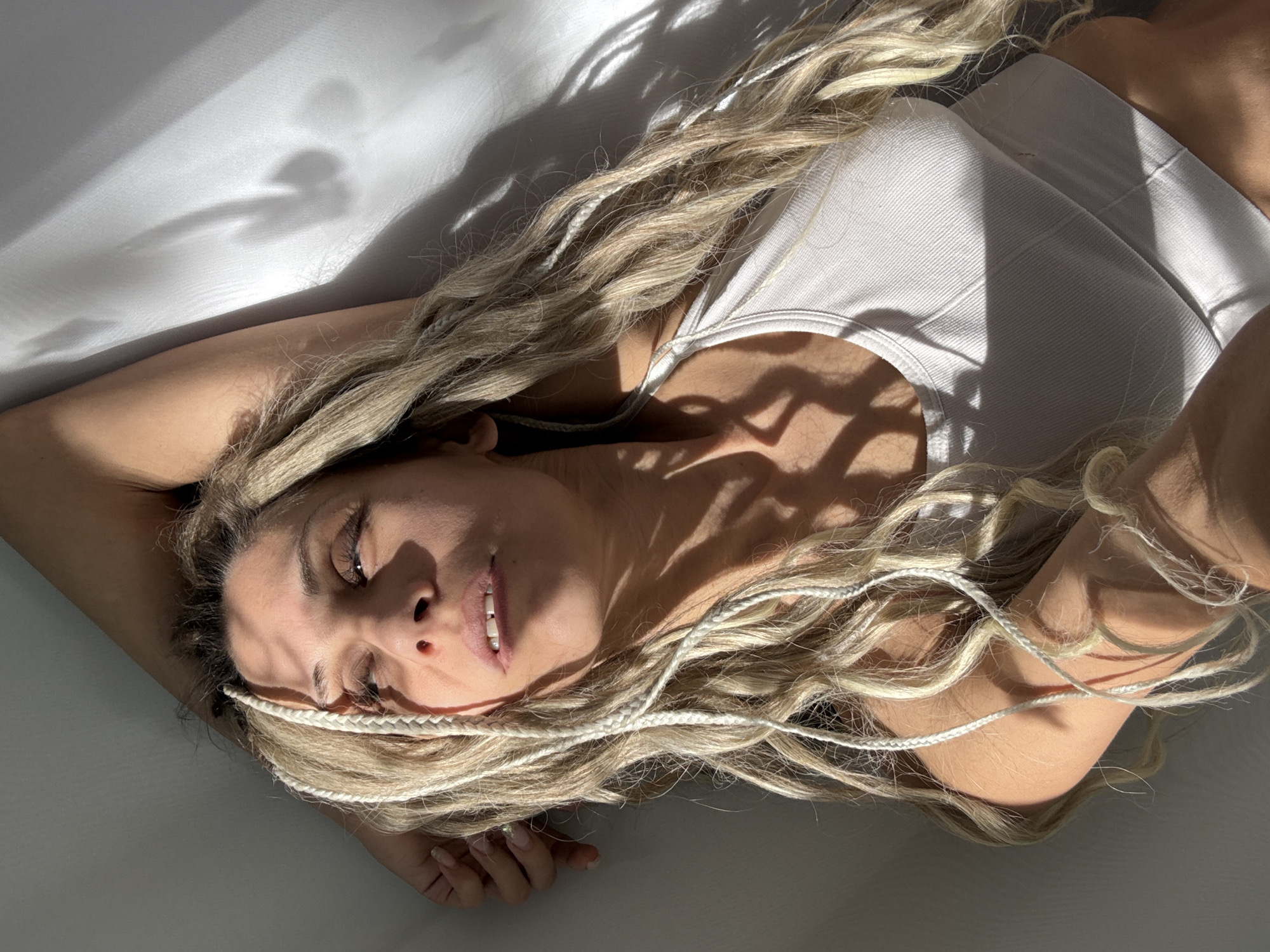 Woman with blonde braids recorded indoors in Russian villages
