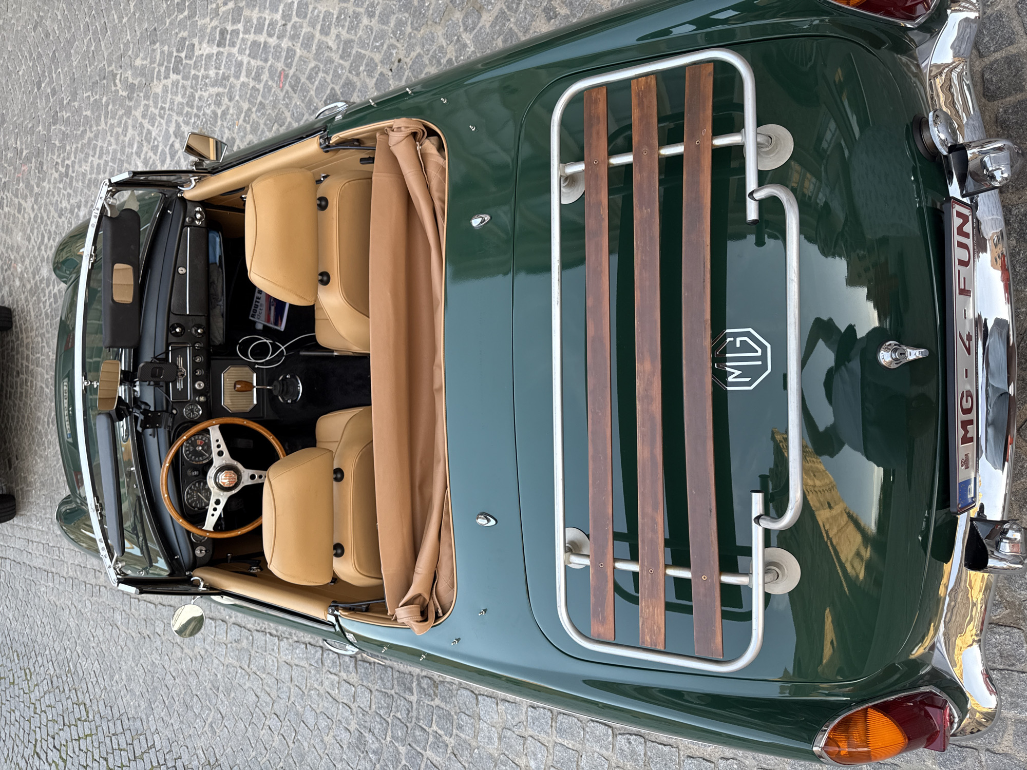 Vintage MG convertible parked among Bruges' Gothic architecture