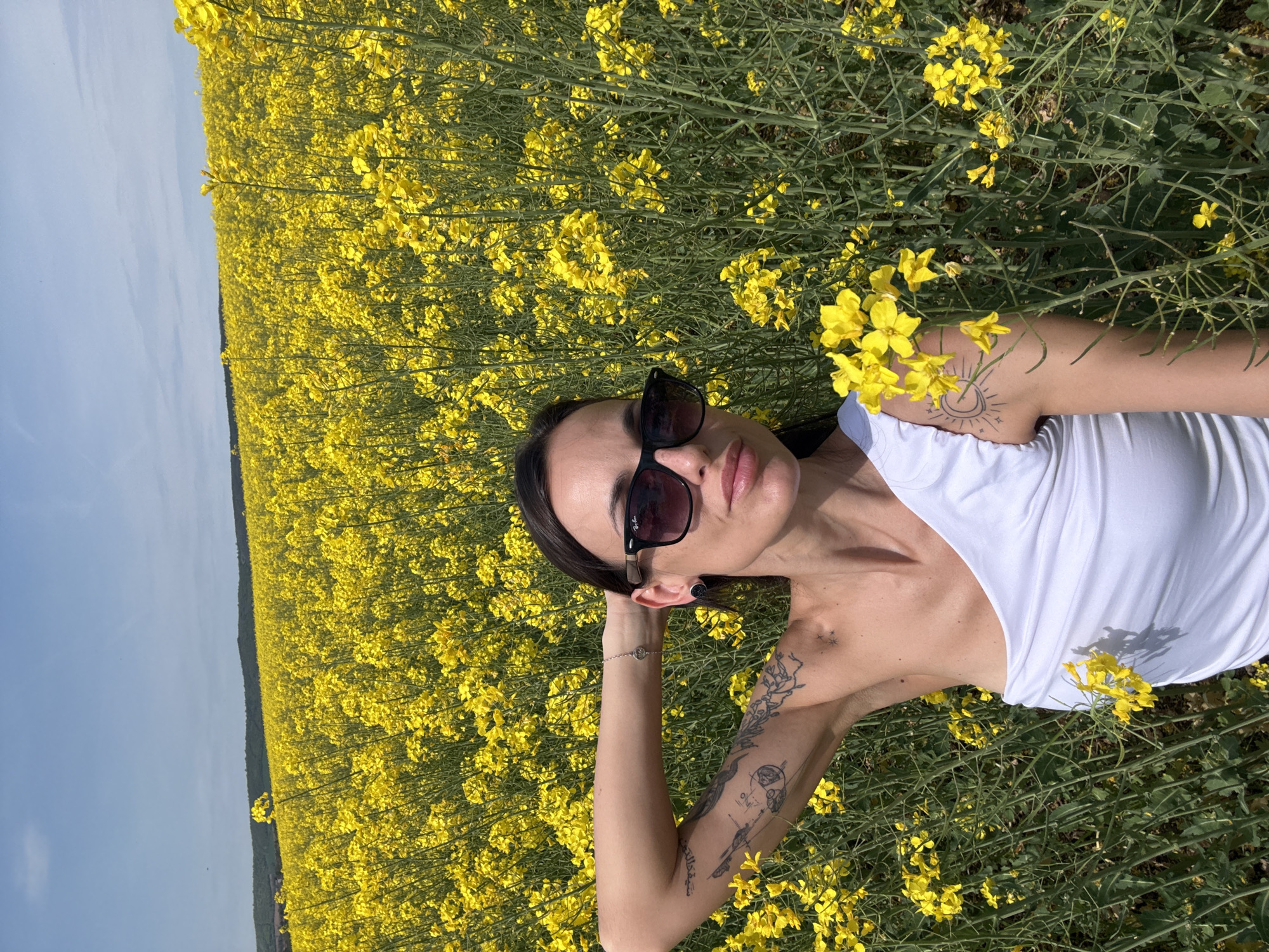 Woman enjoys peaceful moment in yellow flower field in Bulgaria