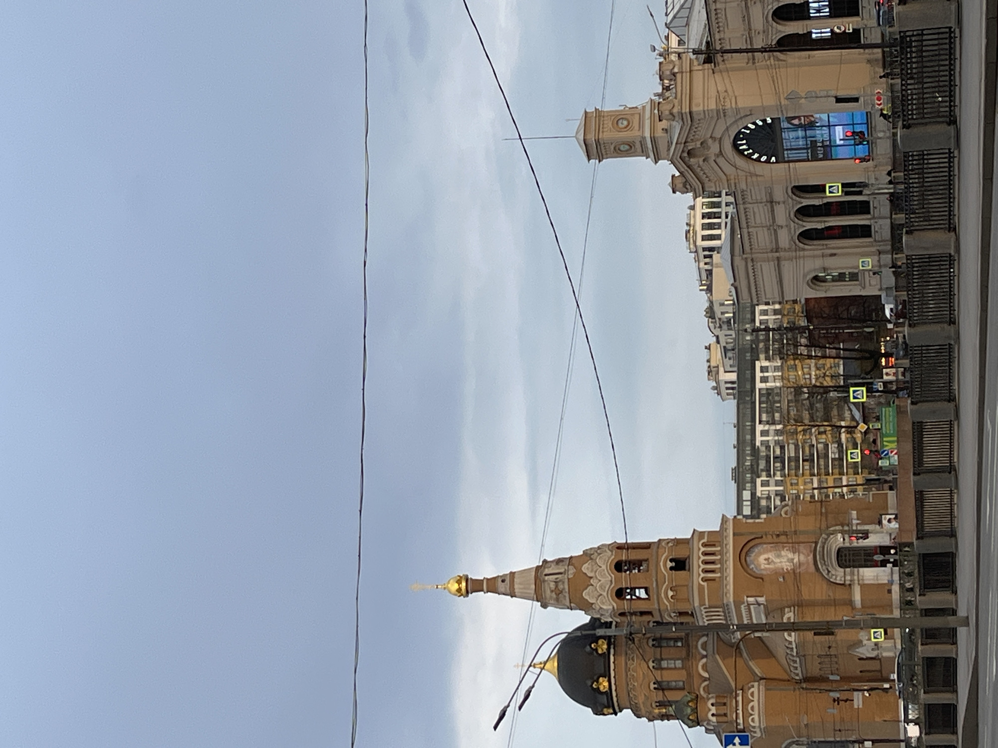 Church with golden spires photographed from multiple angles